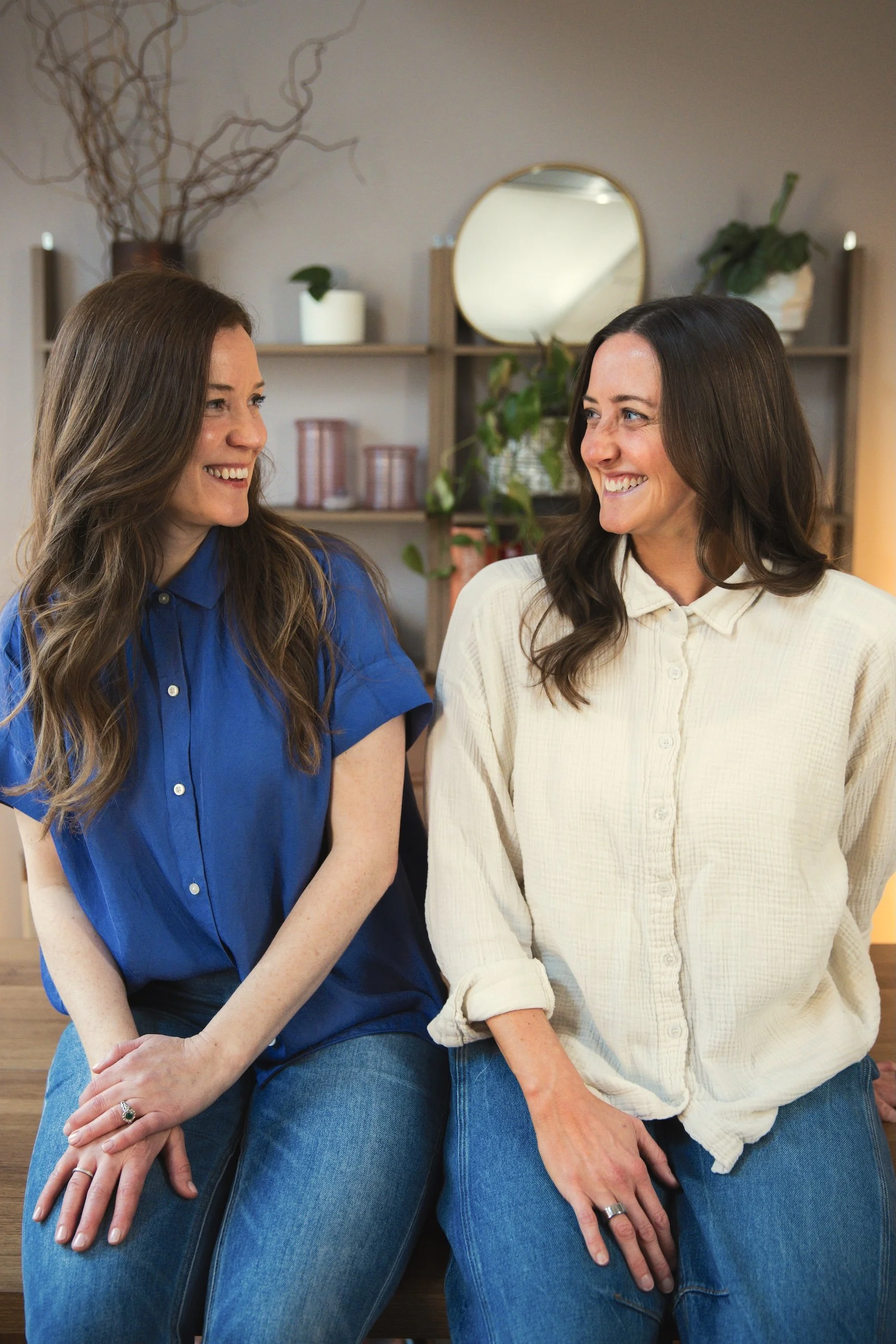 two women looking at each other and smiling for a lifestyle personal brand headshot