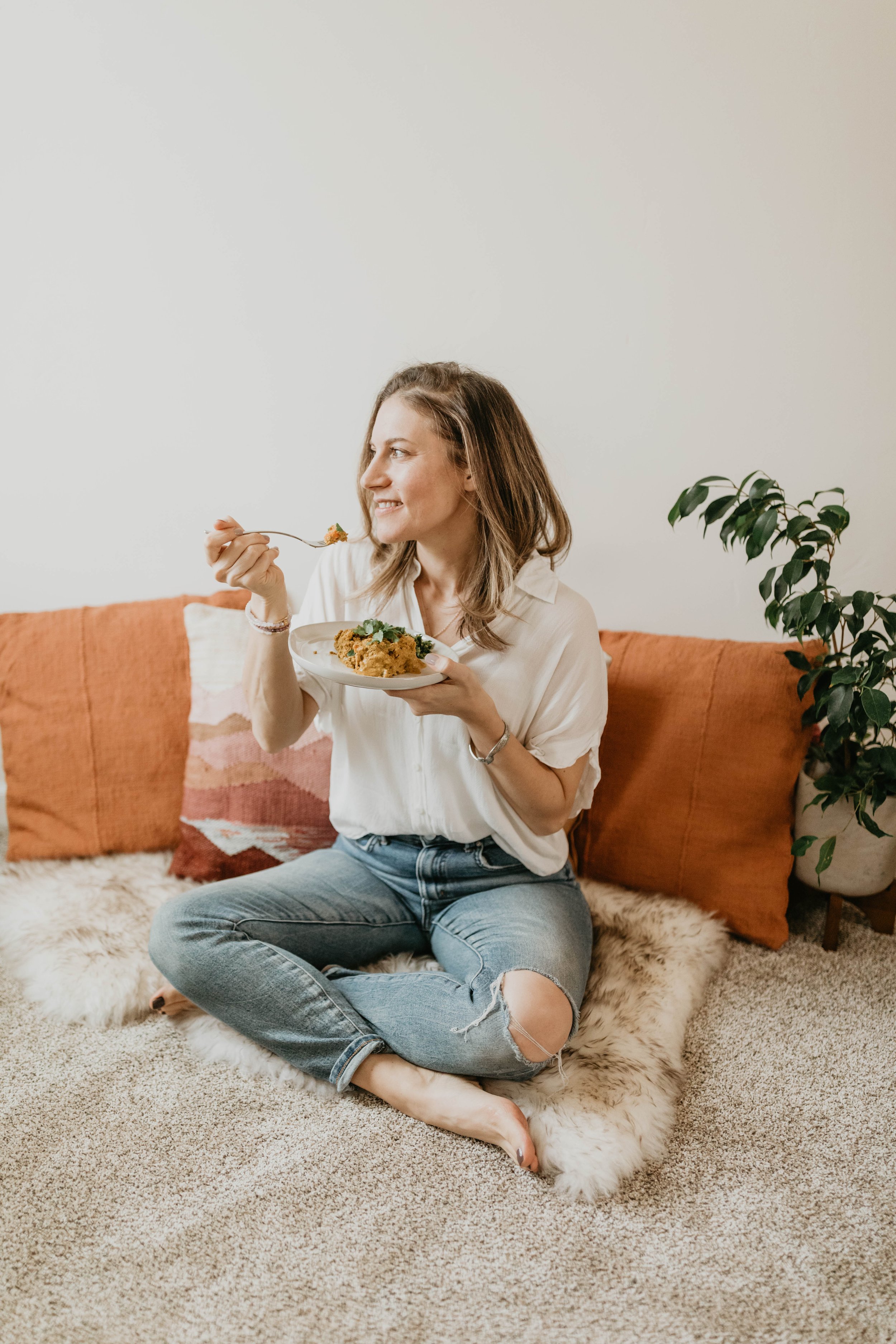 woman sitting on the floor eating nutritious food