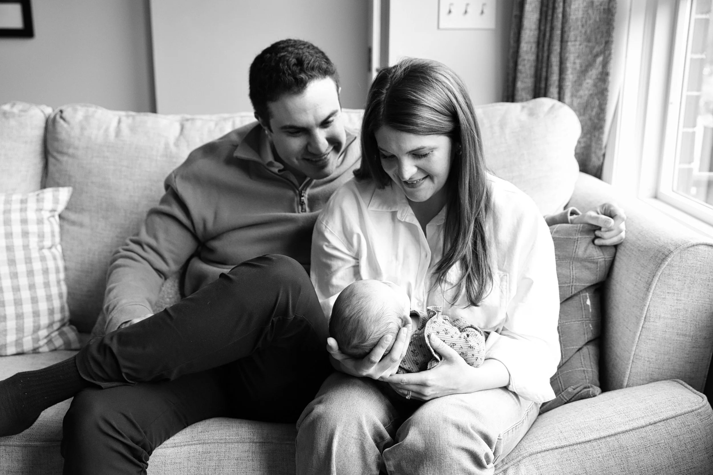 Parents gaze at newborn baby