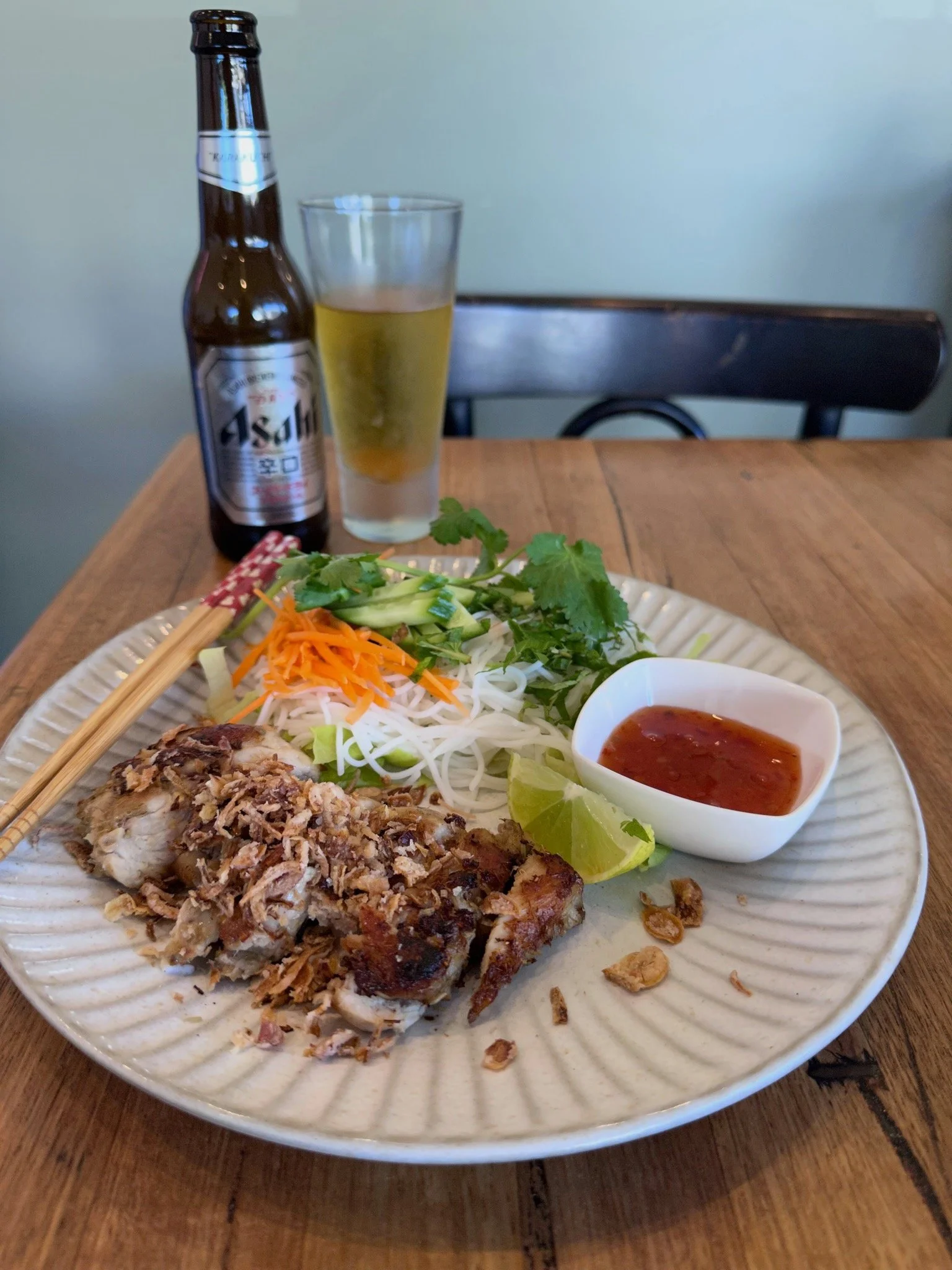 Chicken vermicelli salad with carrot, cucumber and a sweet and spicy sauce. Accompanied by an ice cold Asahi beer. 
