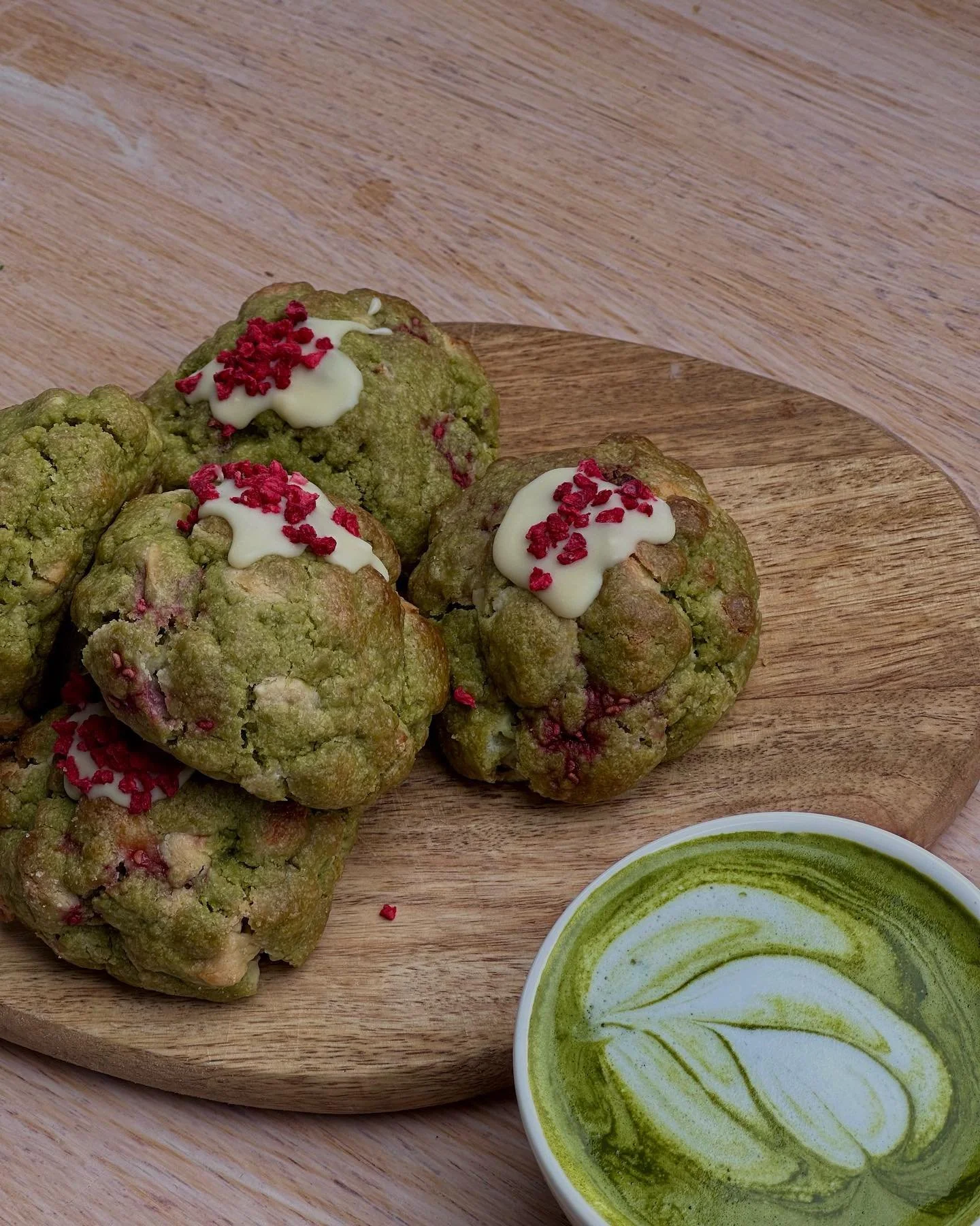 Matcha + Raspberry Cookies with a cup of hot matcha on the side