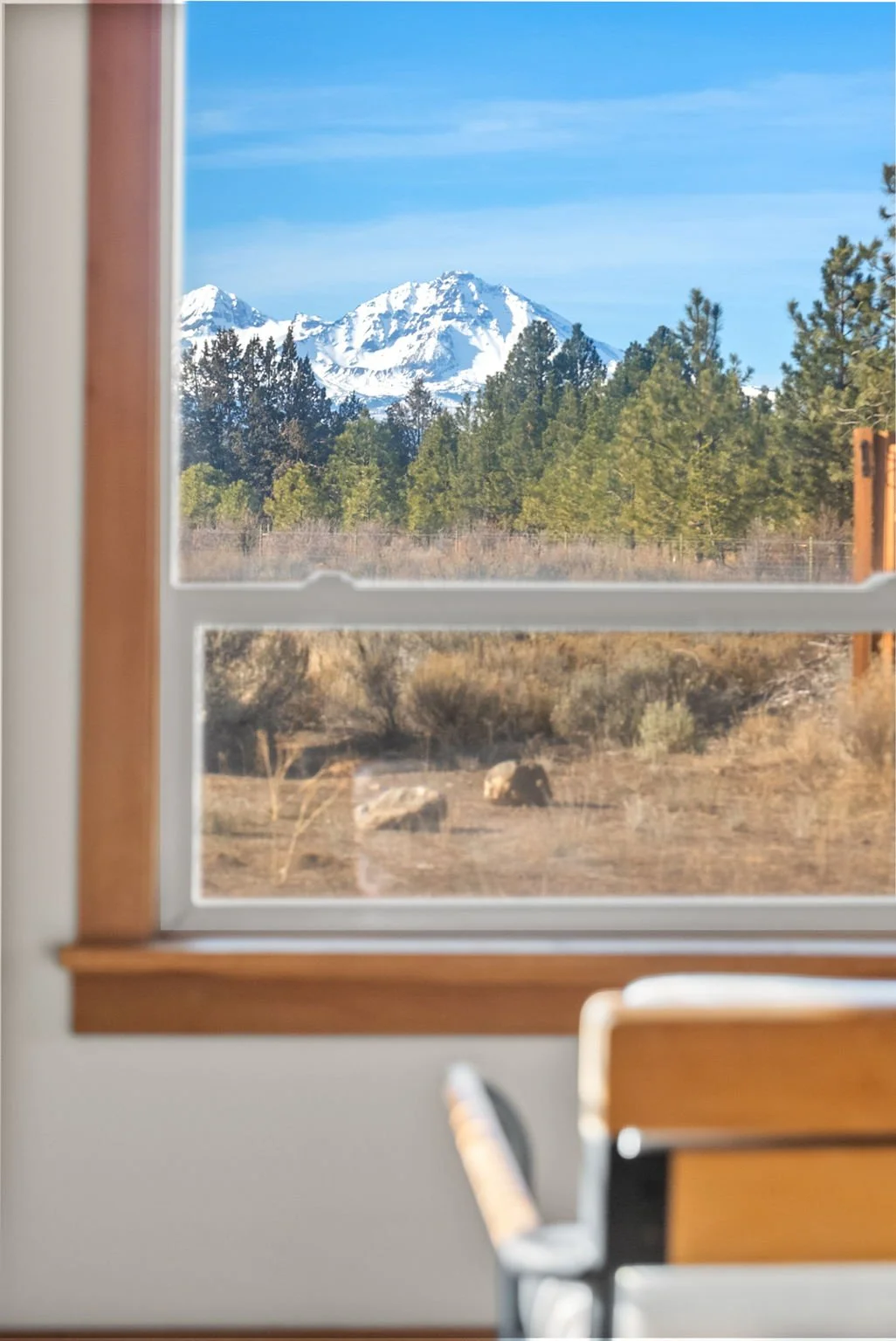 View of one of the Sisters mountains from behind a chair in the sun room