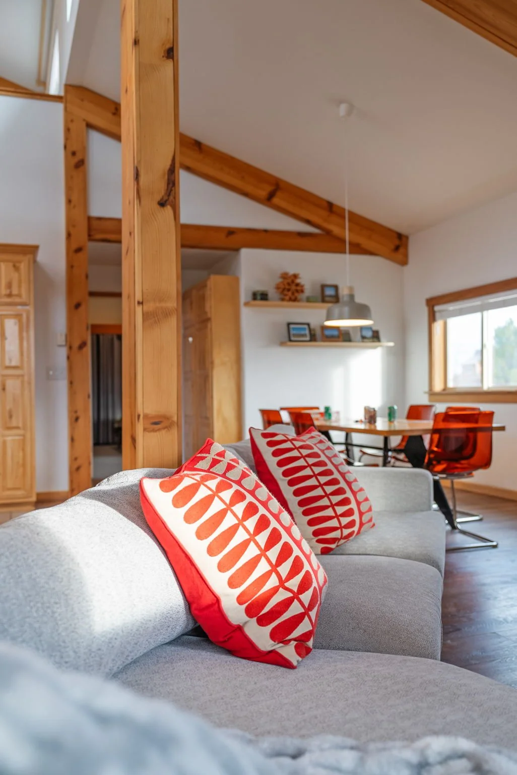A photo looking along the couch to the dining area
