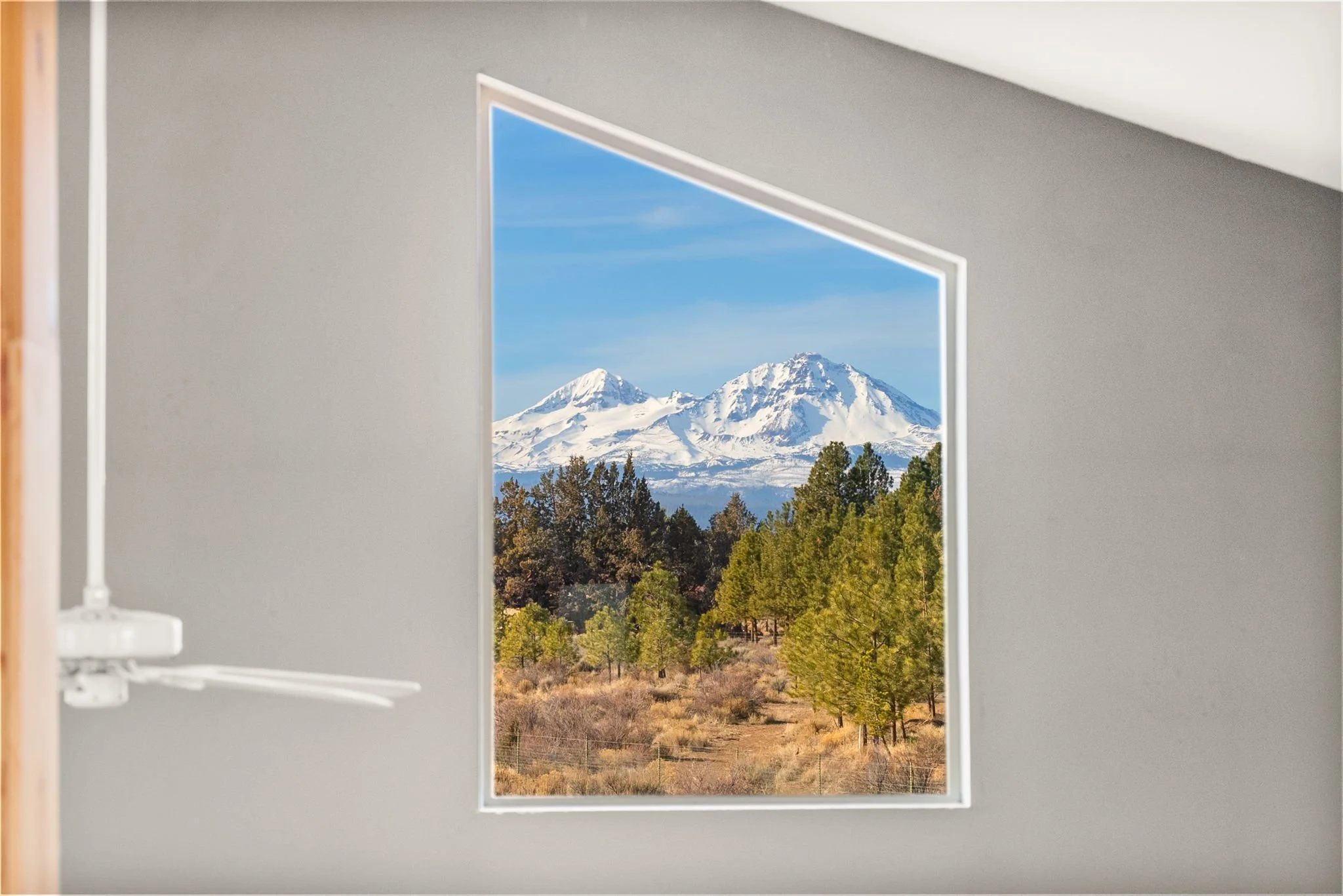 Image of the Three Sisters mountains through the loft window.