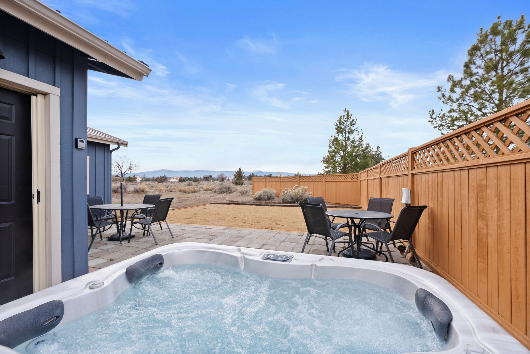Close up of hot tub overlooking the patio with partisl views of the mountains