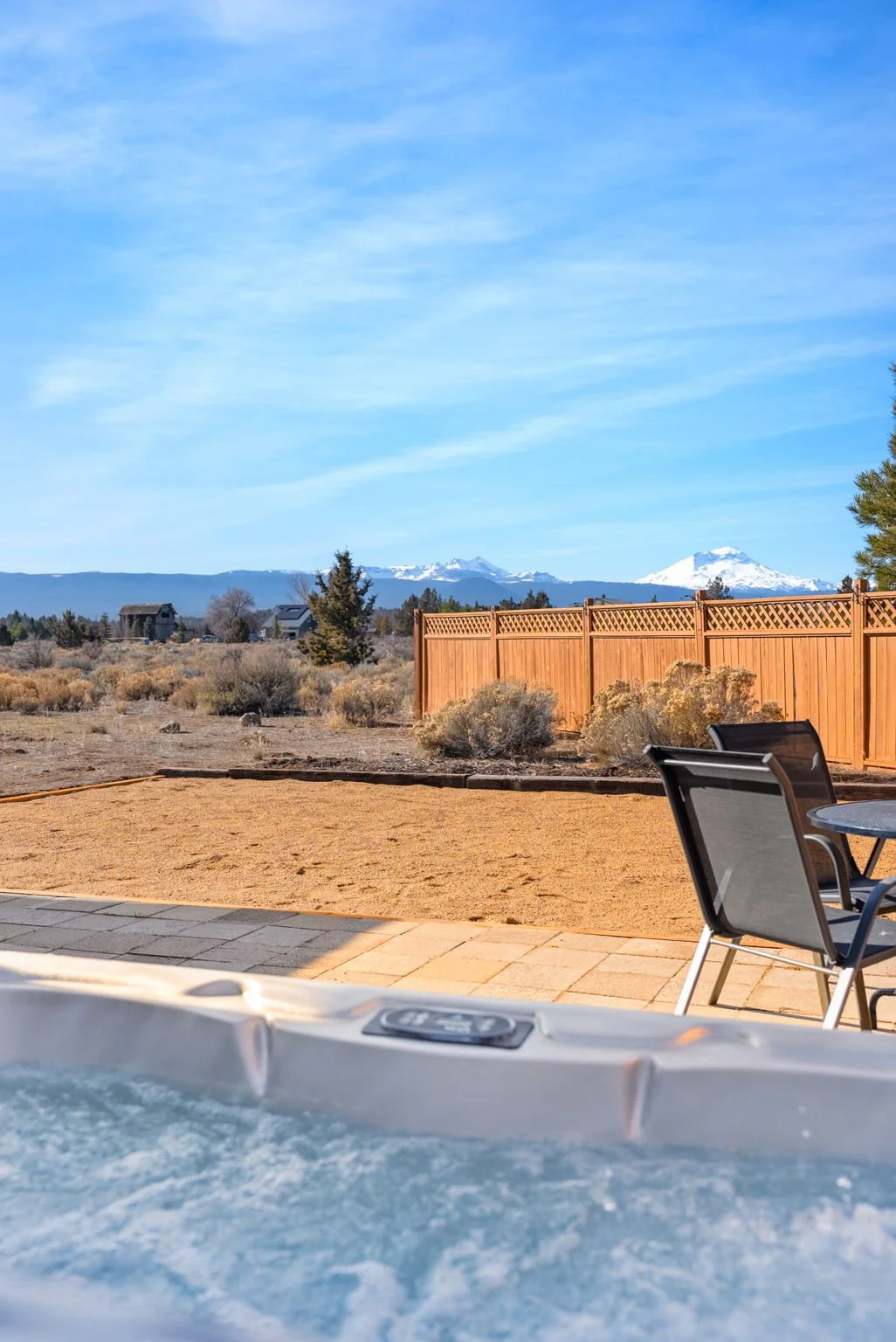 Close up of hot tub overlooking the patio with partisl views of the mountains
