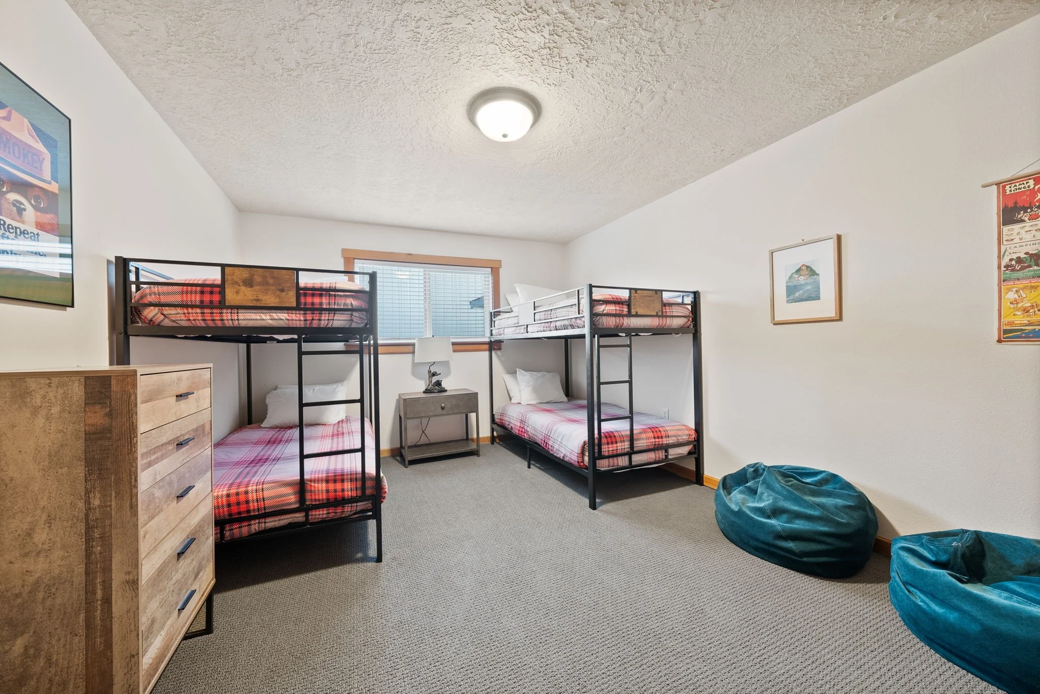 Image of bunk room with four twin beds at Six Mountain View in Sisters, Oregon