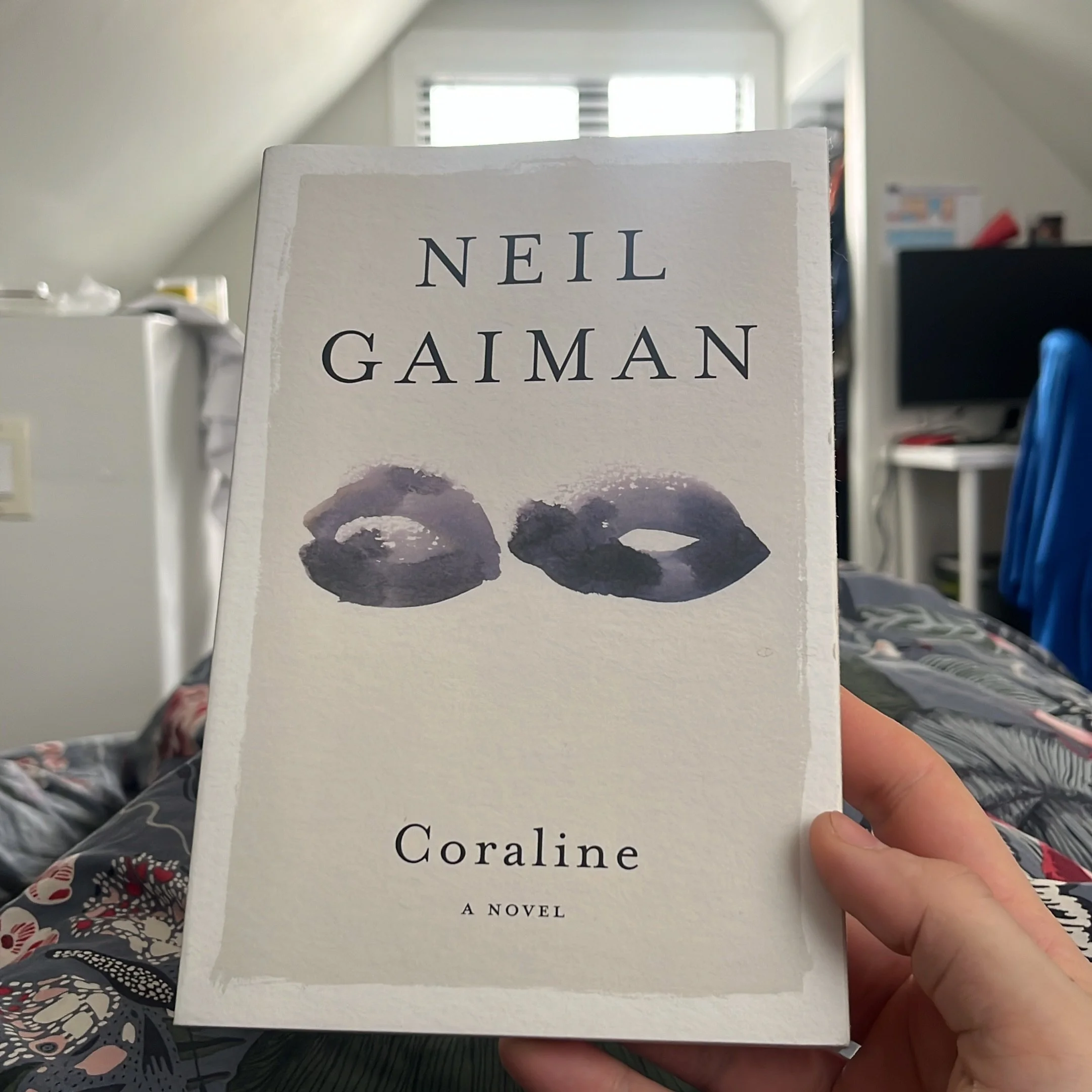 Is there a better book to read in bed?

I first saw the movie Coraline at the end of 2009. I rented it through my TV provider for 24 hours and watched it 3 times. I was totally entranced by the imagery, the characters, the plot, everything! 

I first