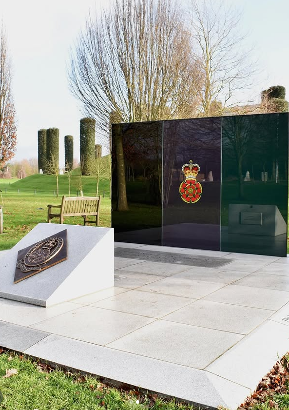 Guilded glass memorial at the National Memorial Arboretum consisting of 2m high panels