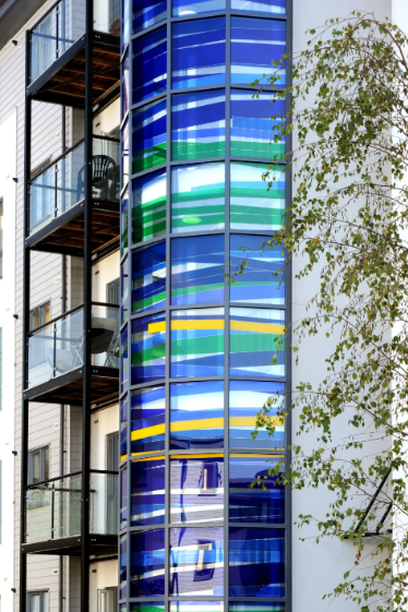 Decorative glazing for two stairwell towers in residential development.