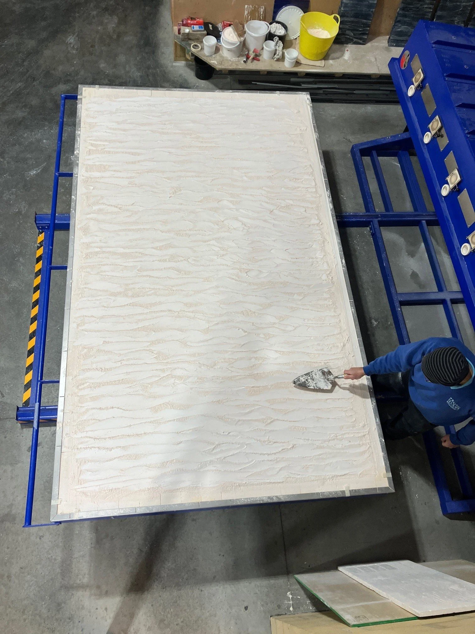 slump glass manufacturers preparing the kiln bed for the next slumped glass