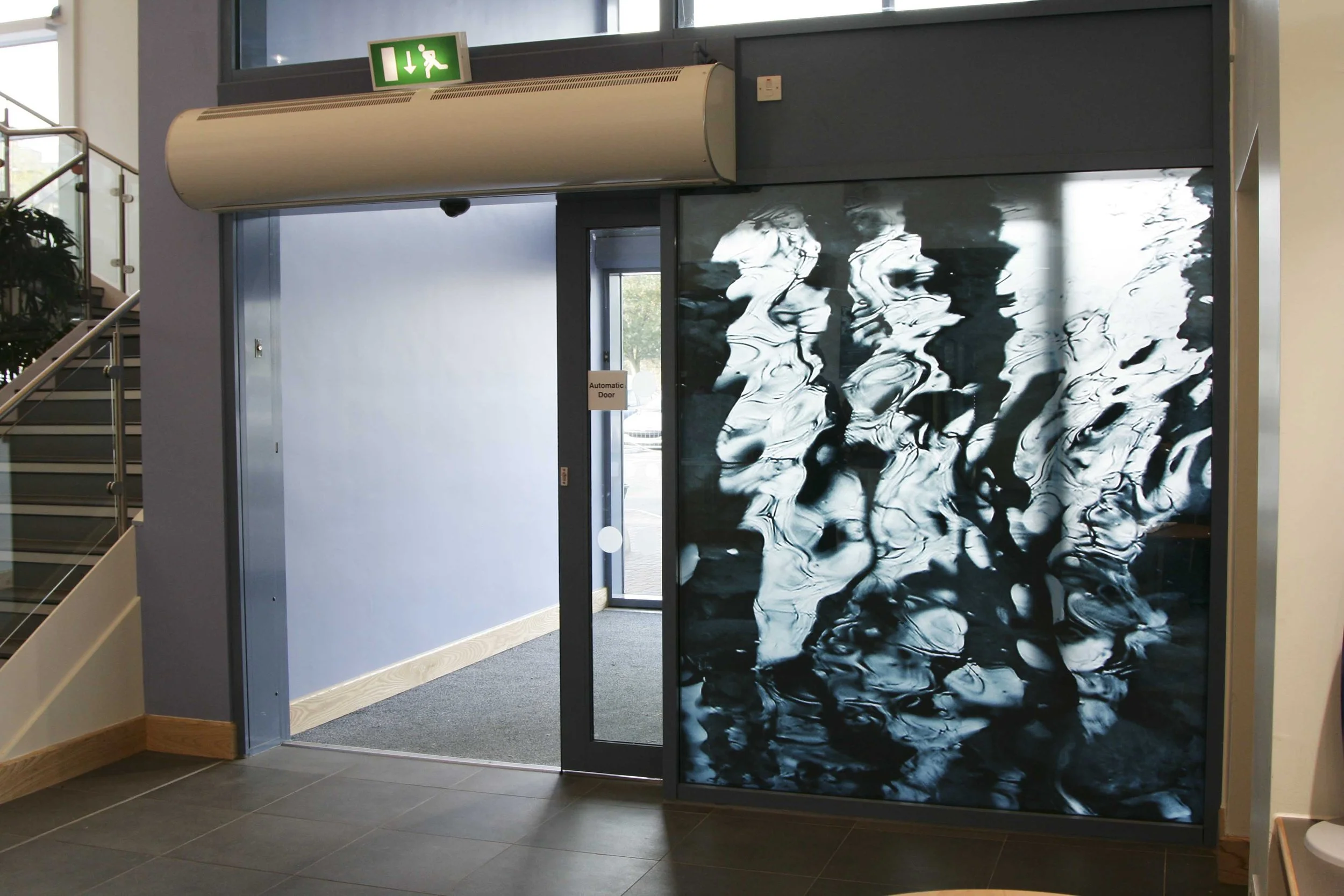 Wentworth Leisure Centre, Hexham. Glass curtain wall . Additional elements of the artwork were incorporated into the entrance glazing, three small windows, and the building’s signage