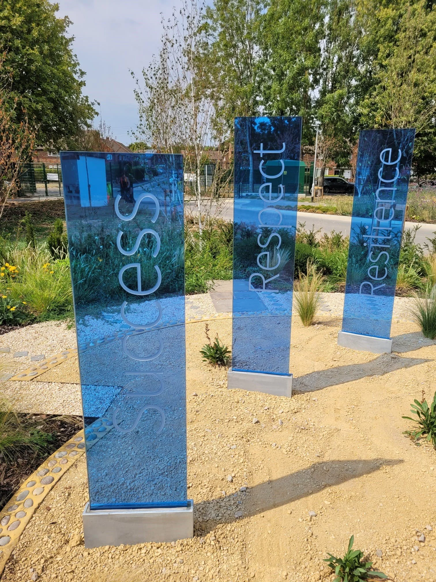 Merstham Park School deeply sandblasted text in blue glass plinths