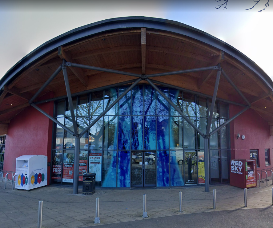 Lesiure centre frontage. Decorative glass facade designed to reflect water by Martin Donlin.