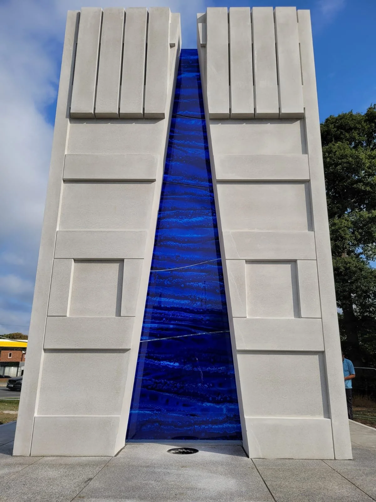 Screen printed blue enamelled glass mimicking slumped glass in a stone sculpture.