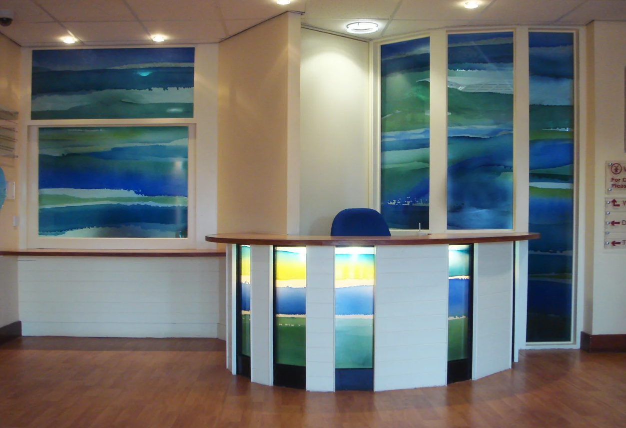 Screen printed transparent enamels on glass for a mental health unit.