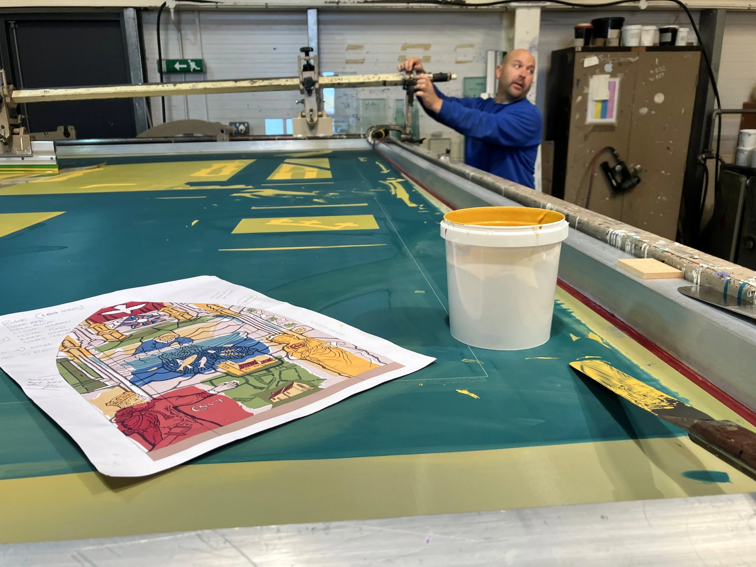 Architectural glass printers at the screen printing bench with an opaque yellow.