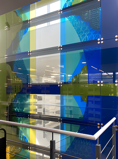 Three storey staircase fin at Winchester University, illuminated and screen printed glass. 52sqm.