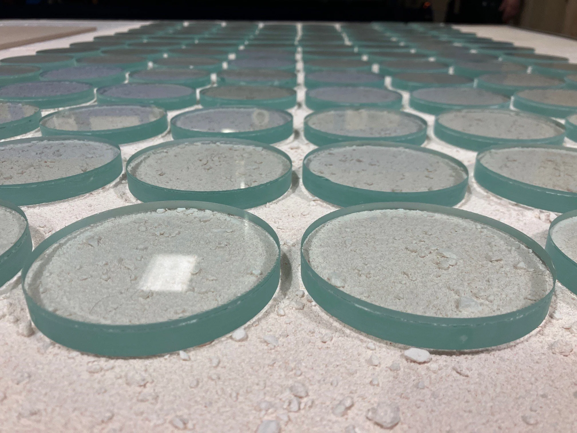 glass slumping circles onto texture kiln bed