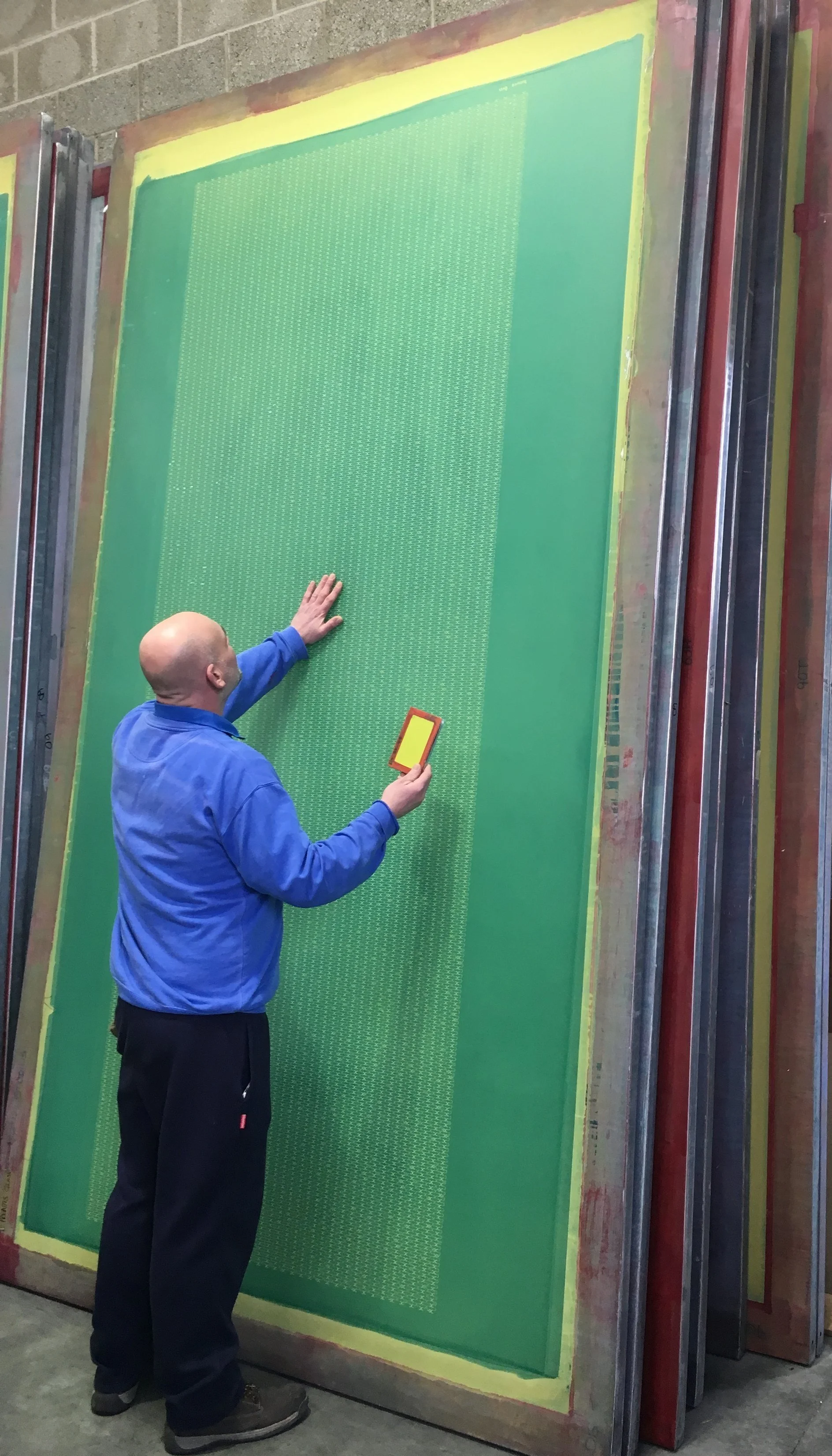 Employee checking the prepared screen printing screen.