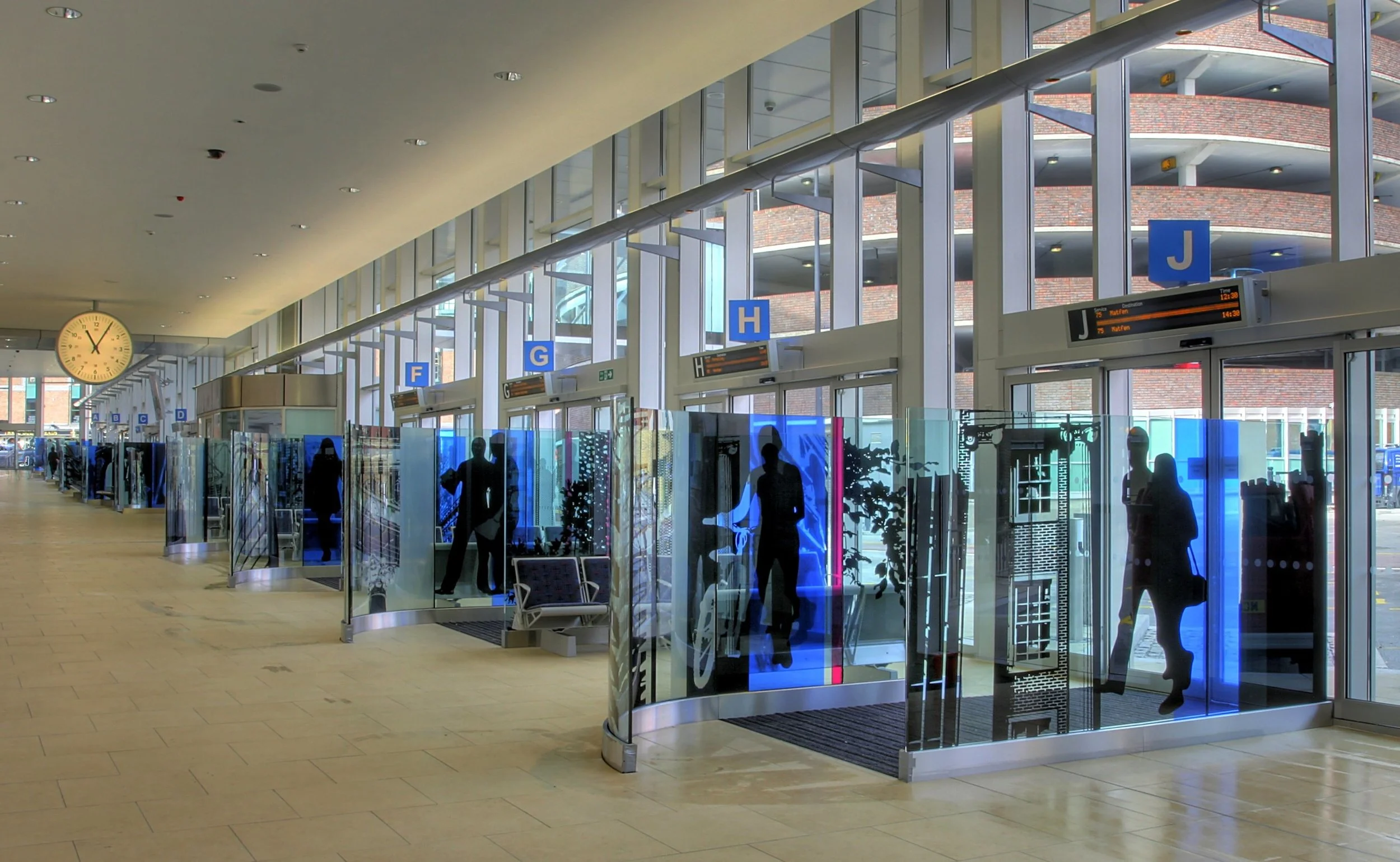 Screenprinted and curved glass bus station panels by Dan Savage at Artstop studios