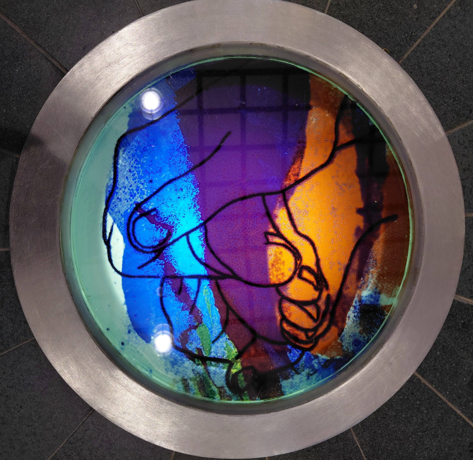 Colourful screen pritned enamel porthole in a local church.