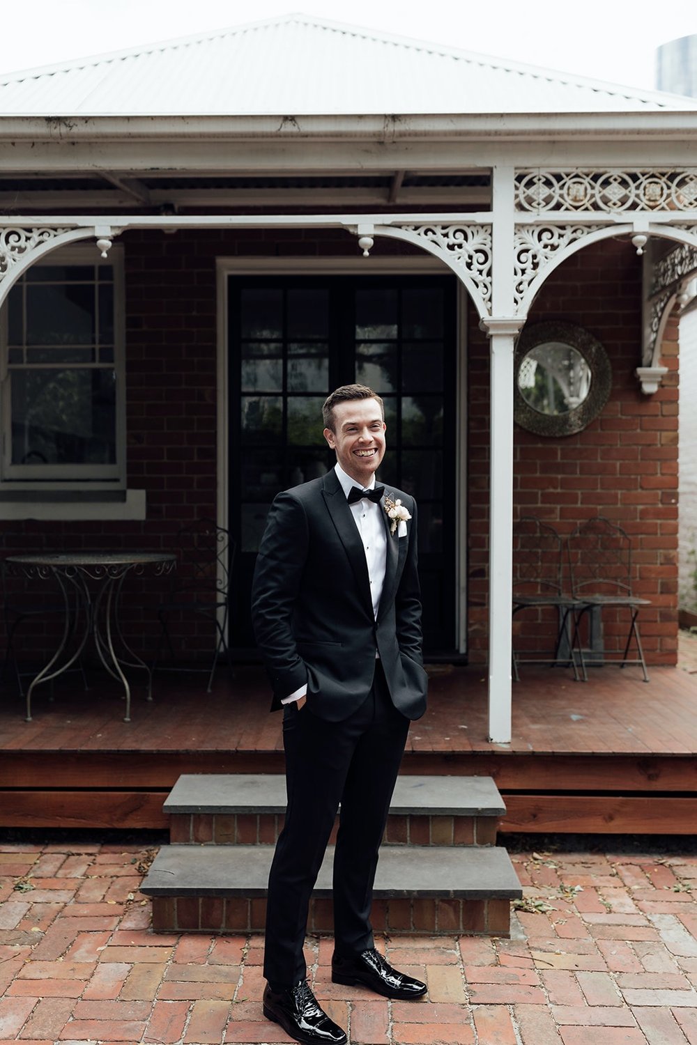 Groom standing with boutonniere in Melbourne Wedding