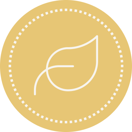 A gold-colored circular badge with a white leaf outline in the center.