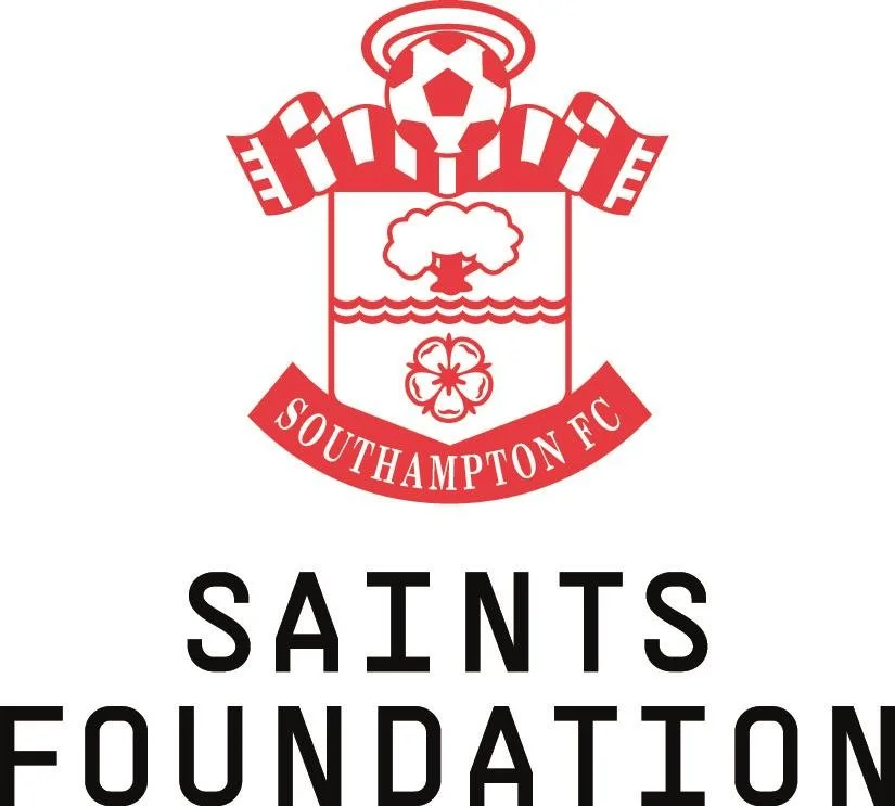 Southampton Football Club crest with a soccer ball, a tree, and a four-leaf clover, with the text 'Southampton FC' and 'Saints Foundation' underneath.