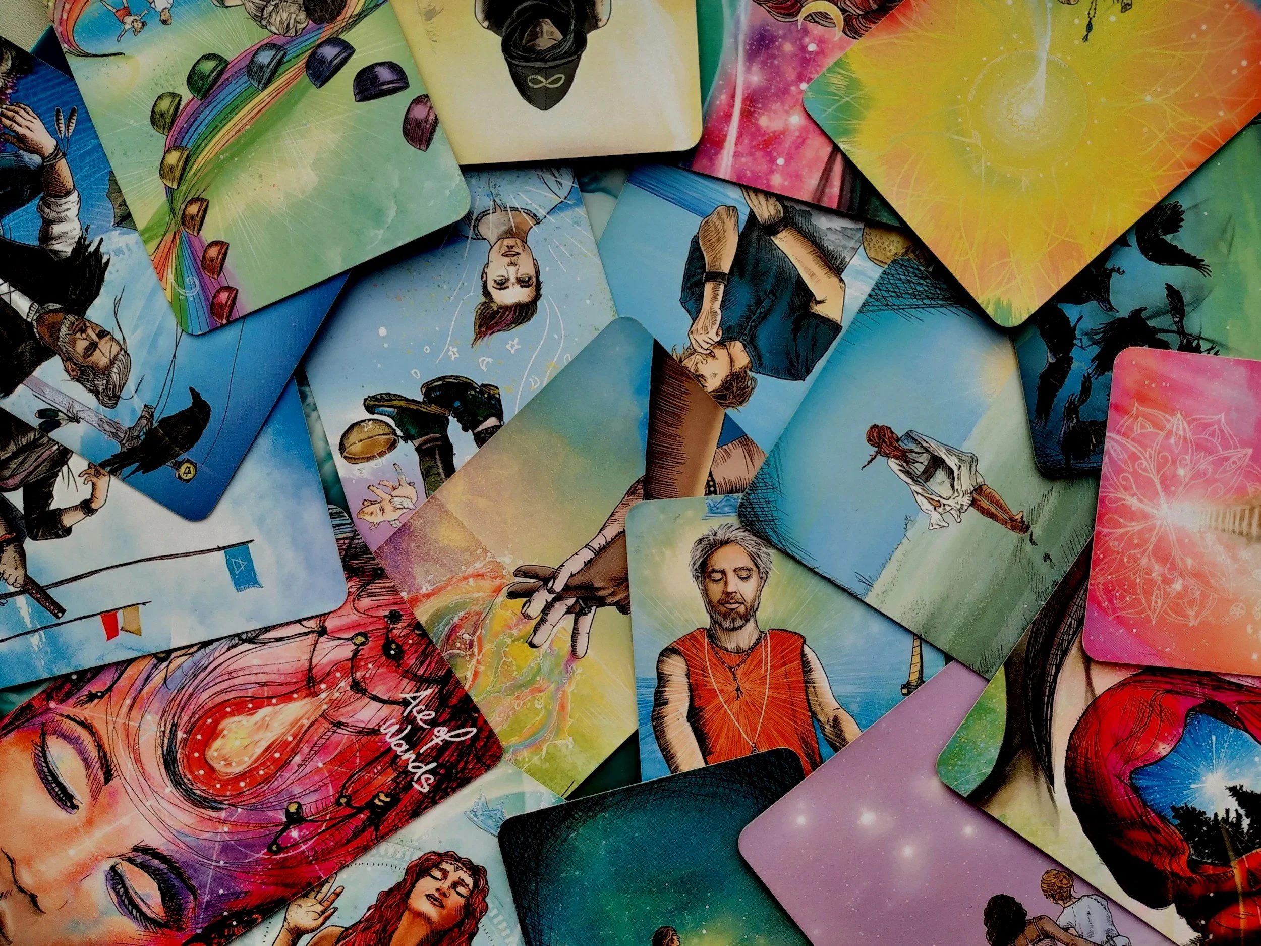 A collection of colorful tarot cards laid out on a surface