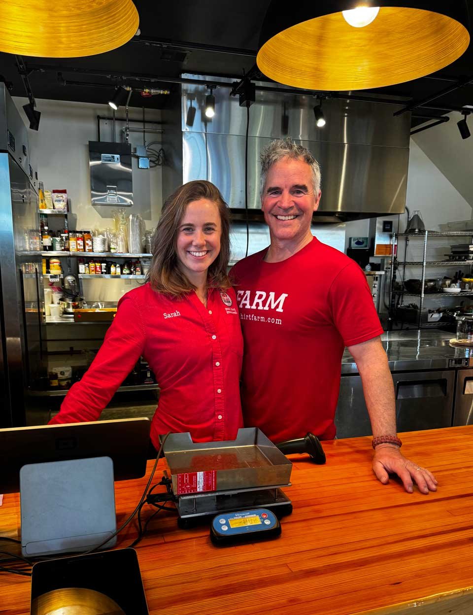 Jim and Sarah Schultz, owners of Red Shirt Farm Market, standing behind the counter in Lanesborough, MA