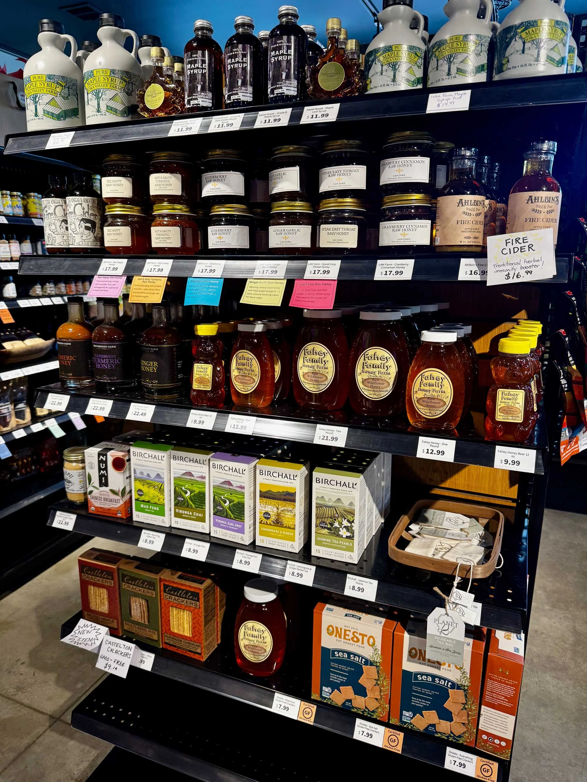 Shelves of local honey, maple syrup, and pantry goods at Red Shirt Farm Market, Lanesborough, MA