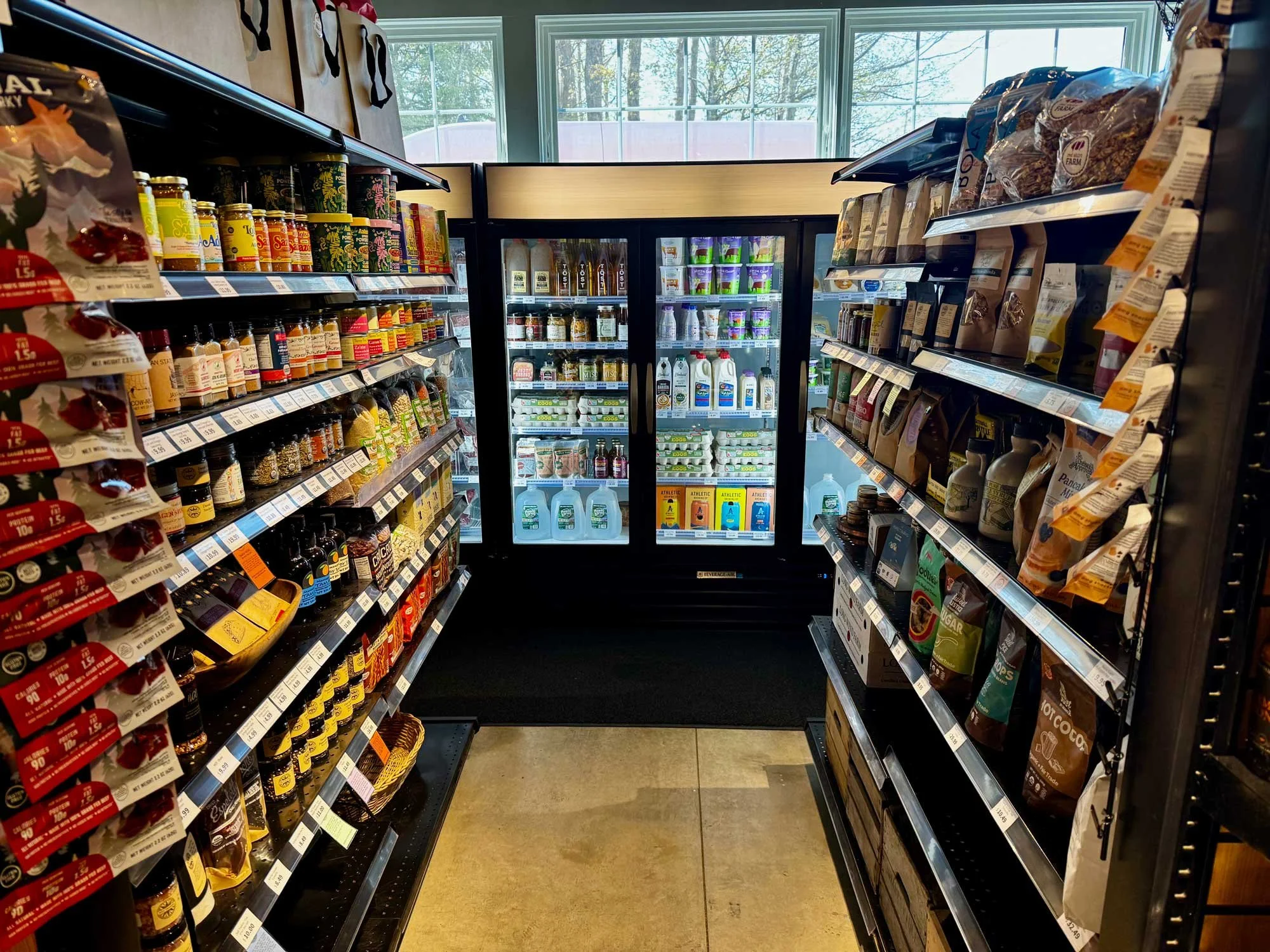 Interior of Red Shirt Farm Market showing shelves of local pantry goods and refrigerated products, Lanesborough, MA