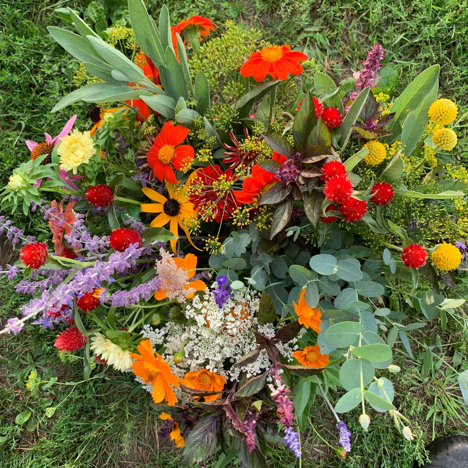 A fresh-cut flower bouquet from Red Shirt Farm featuring mixed seasonal blooms including zinnias, marigolds, and other pollinator-friendly flowers