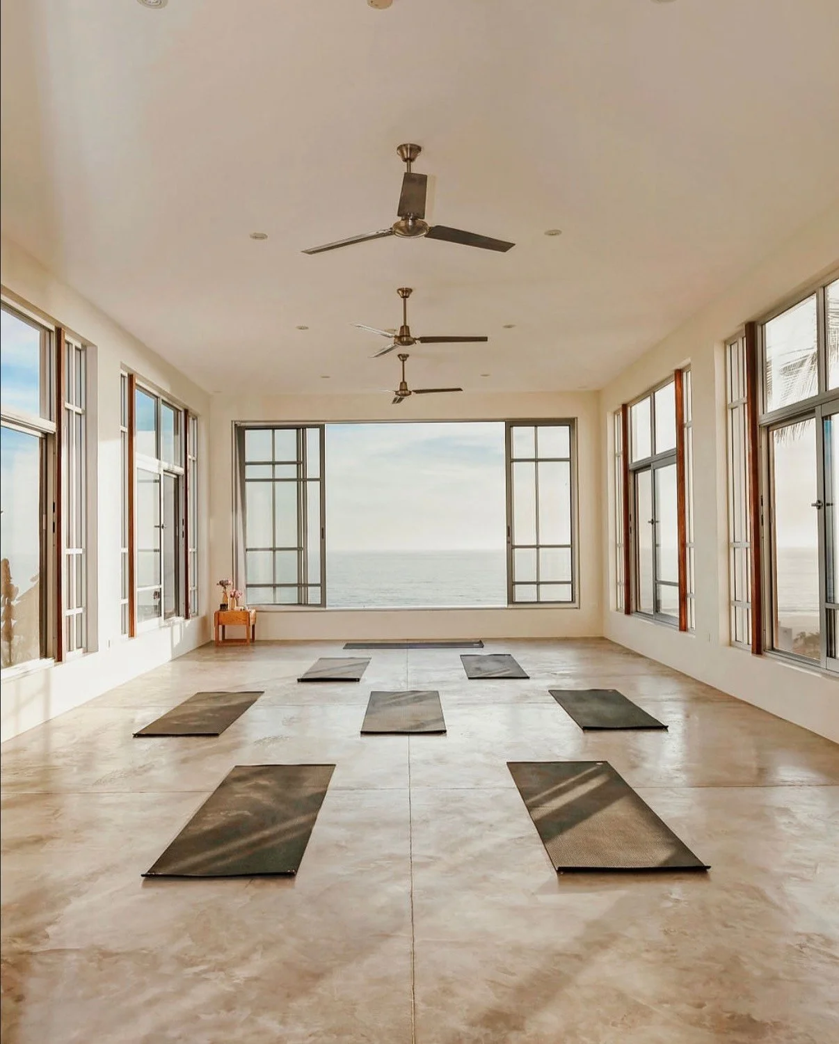 A workout room with 8 mats overlooks the ocean at a retreat center in mexico