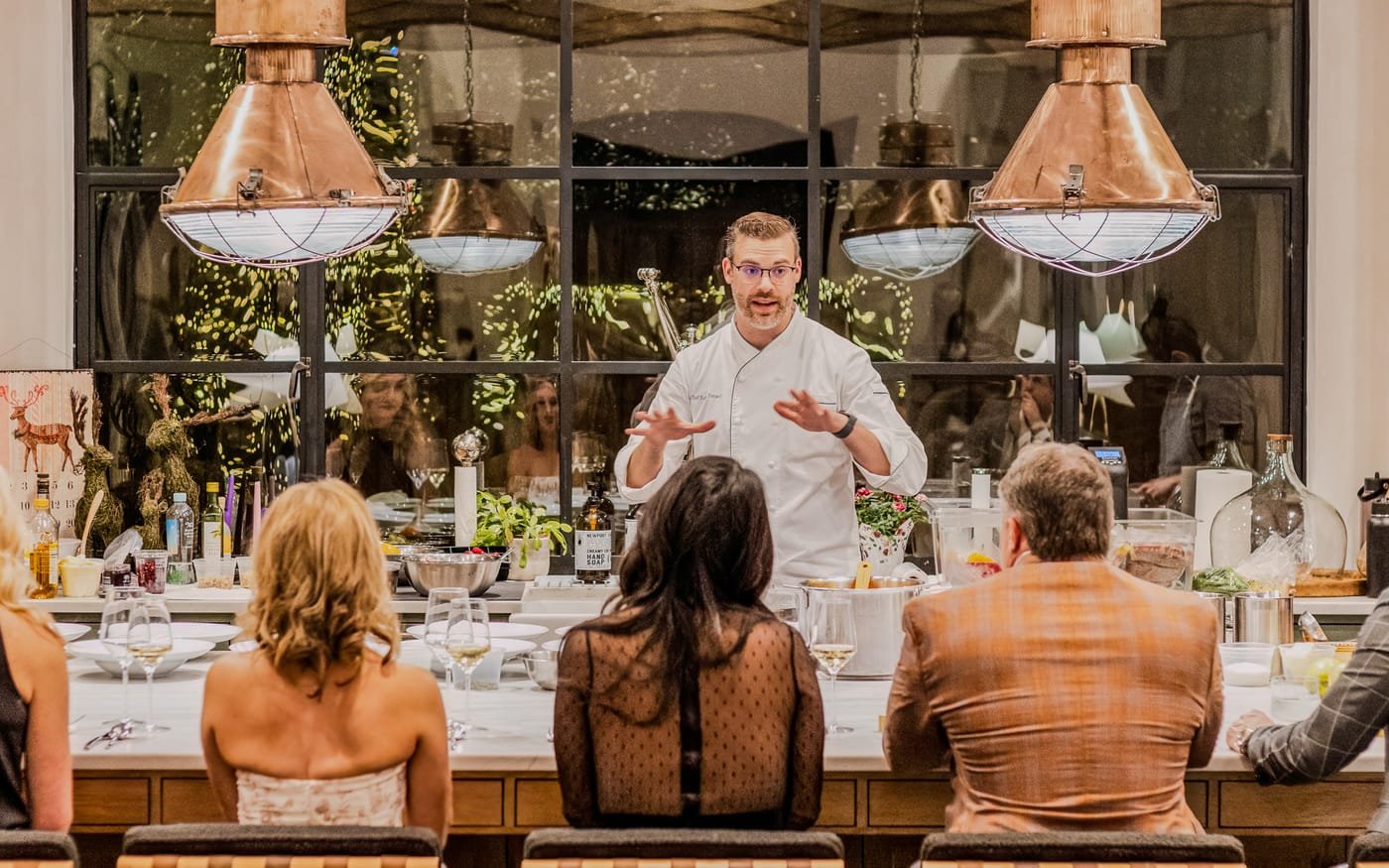 Chef presenting a private dining experience to guests at The Luxury Tree House in Houston.