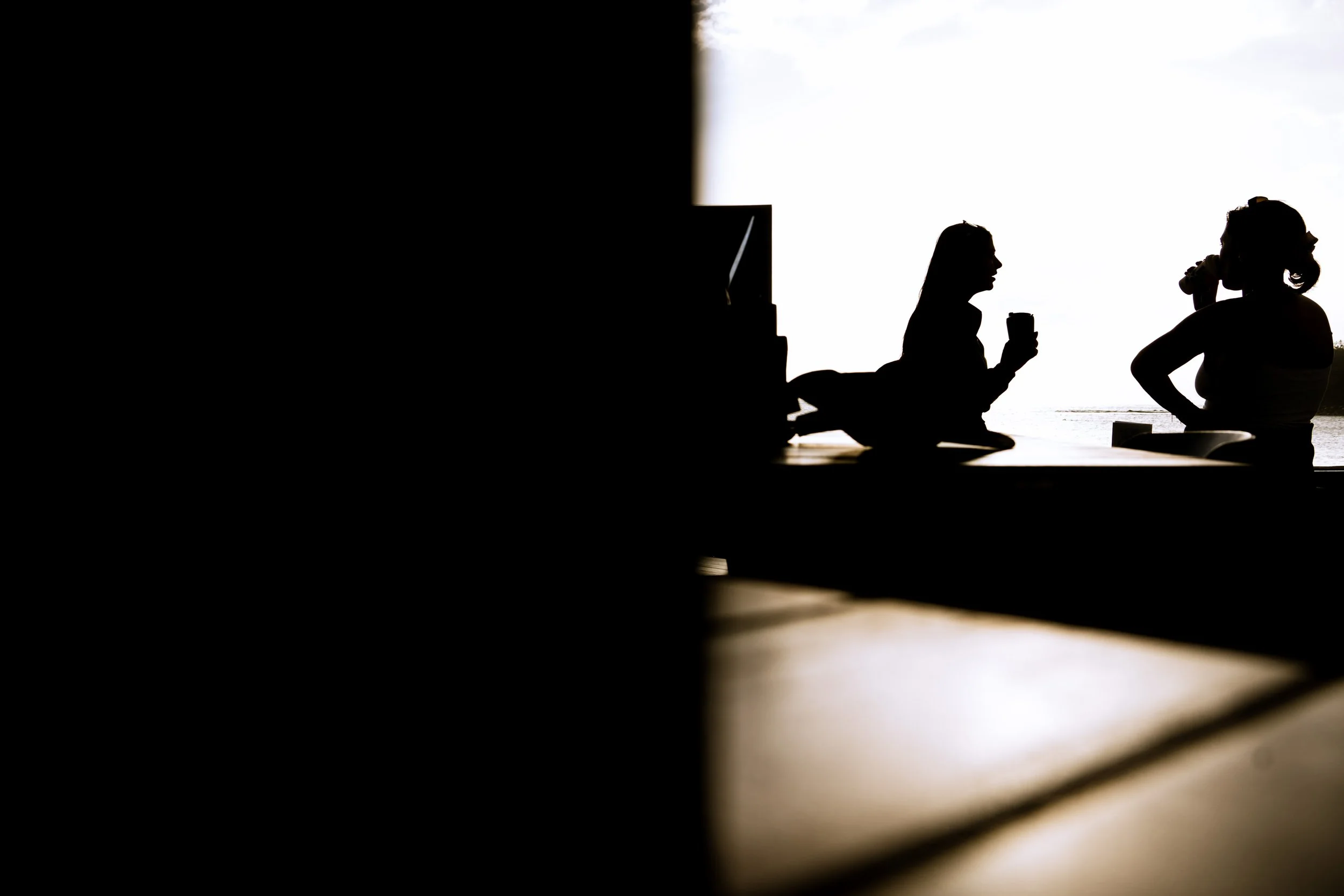 Two women having a coffee at sunrise in Manly, Sydney, Australia