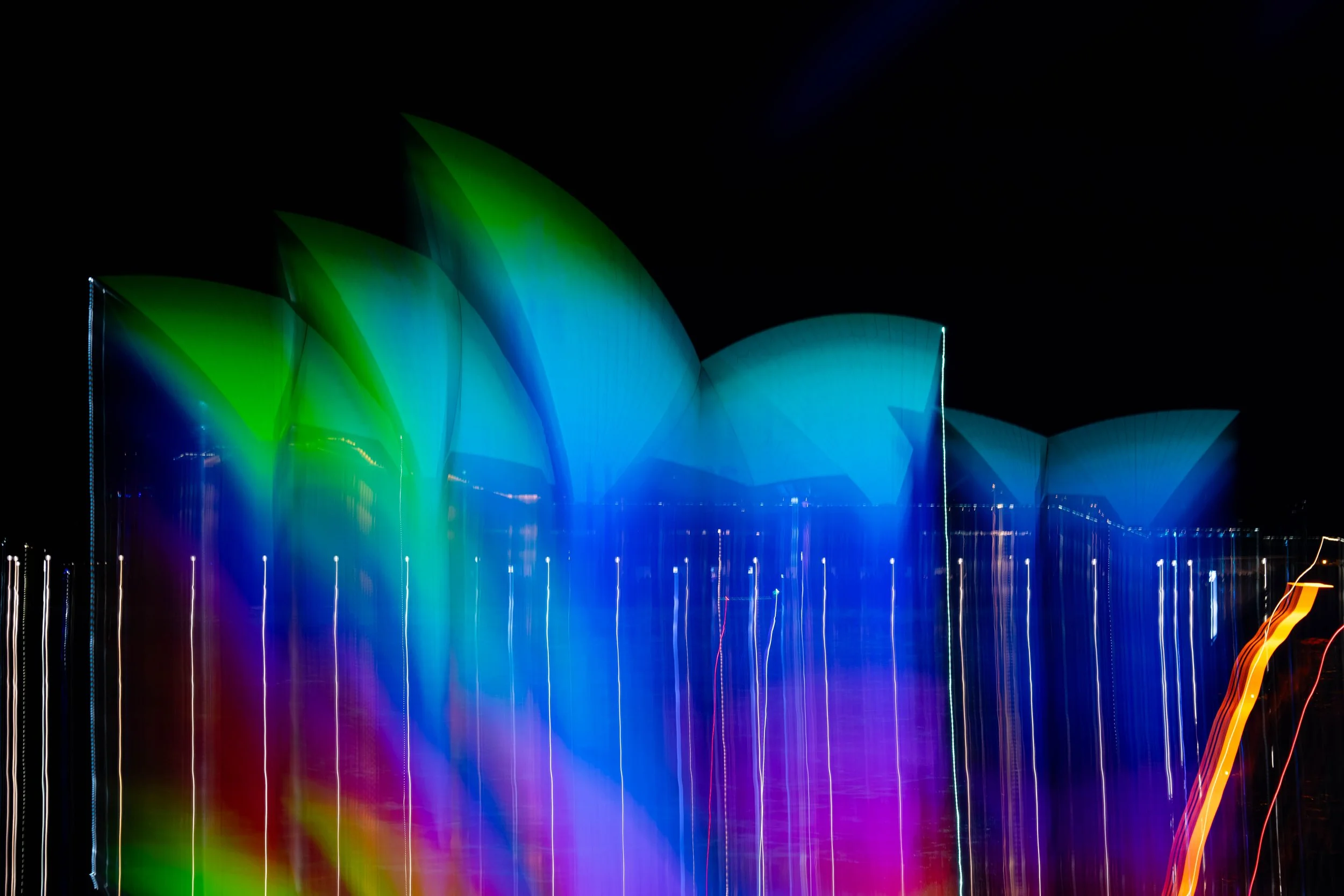 Sydney Opera House lit by colourful lights during Vivid 