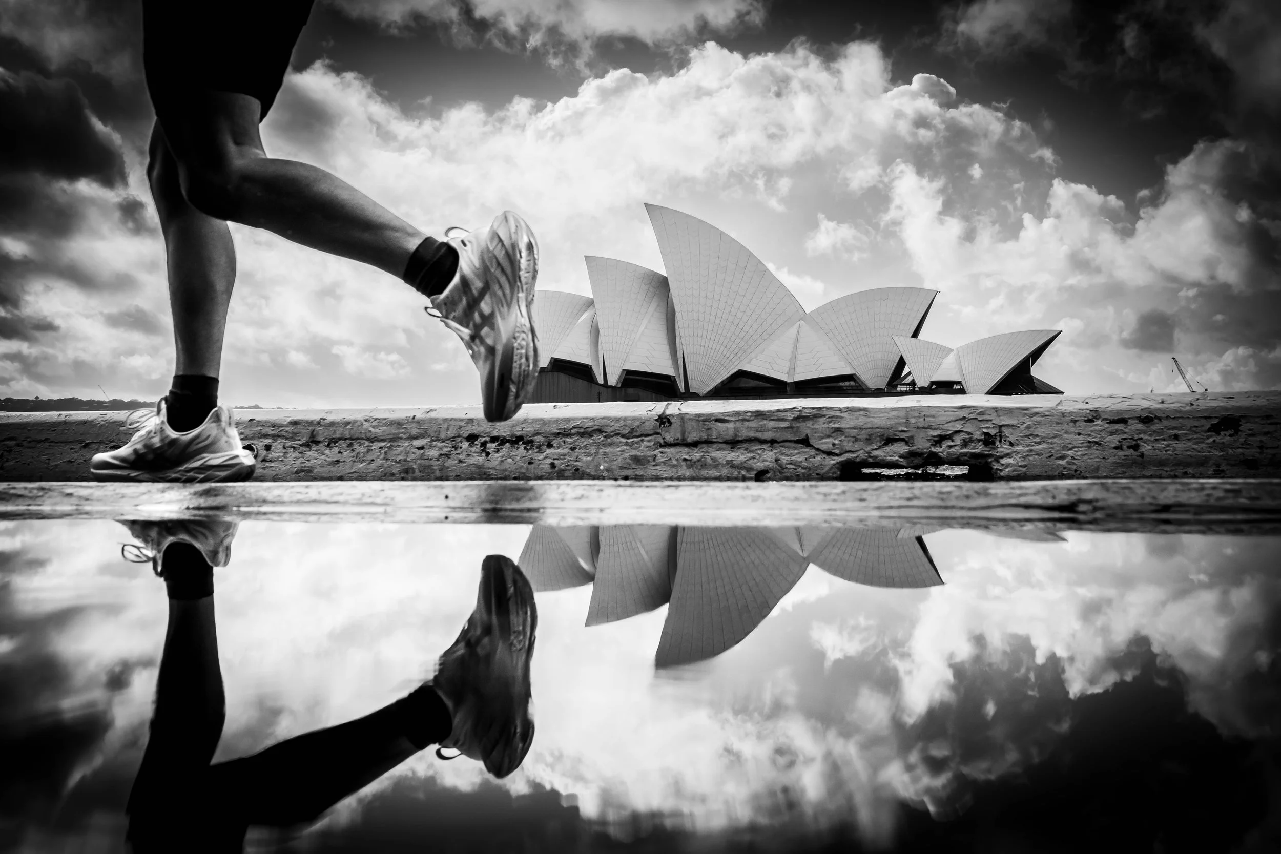 A reflection of a runner and Sydney Opera House