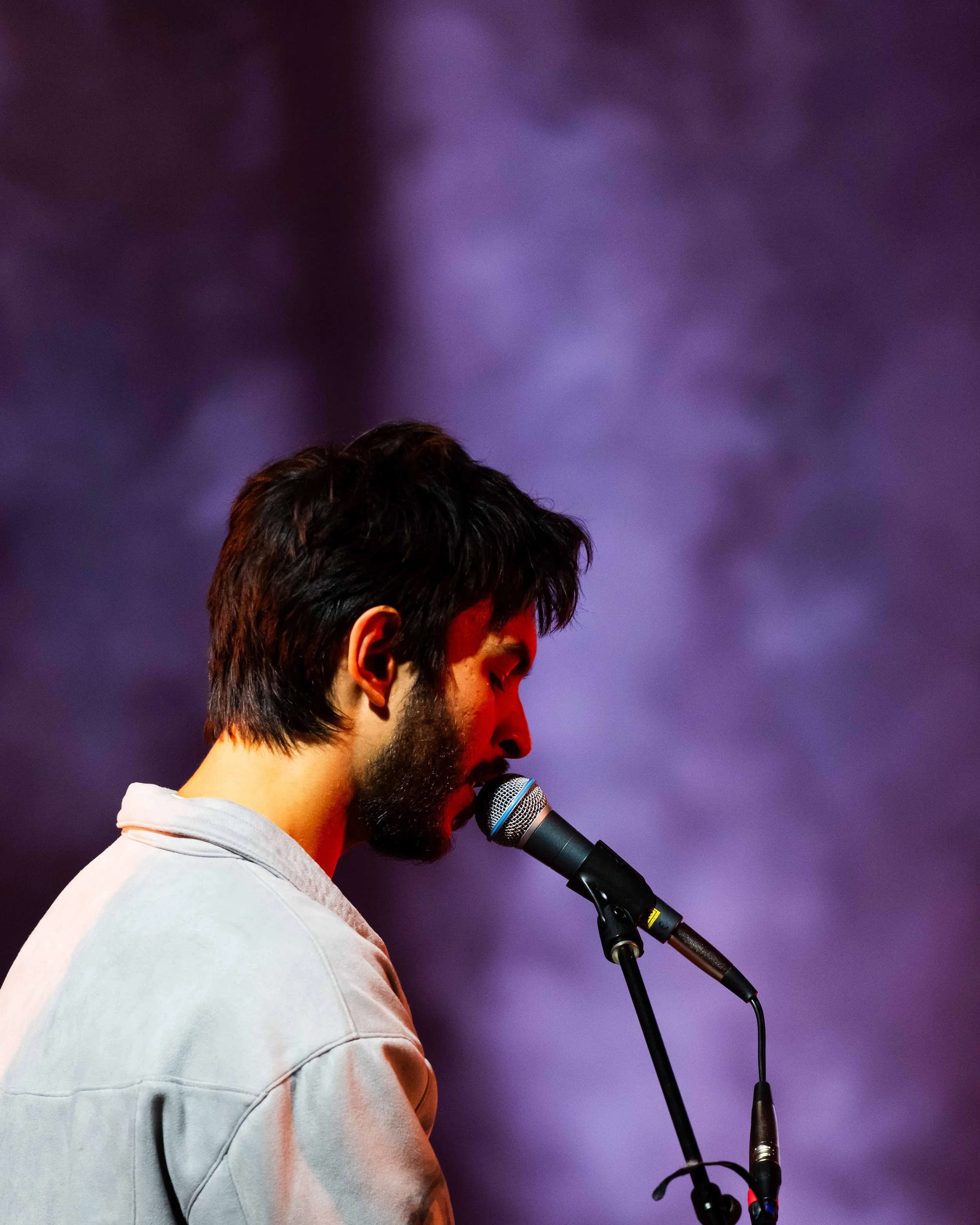 Male singer on stage with a microphone