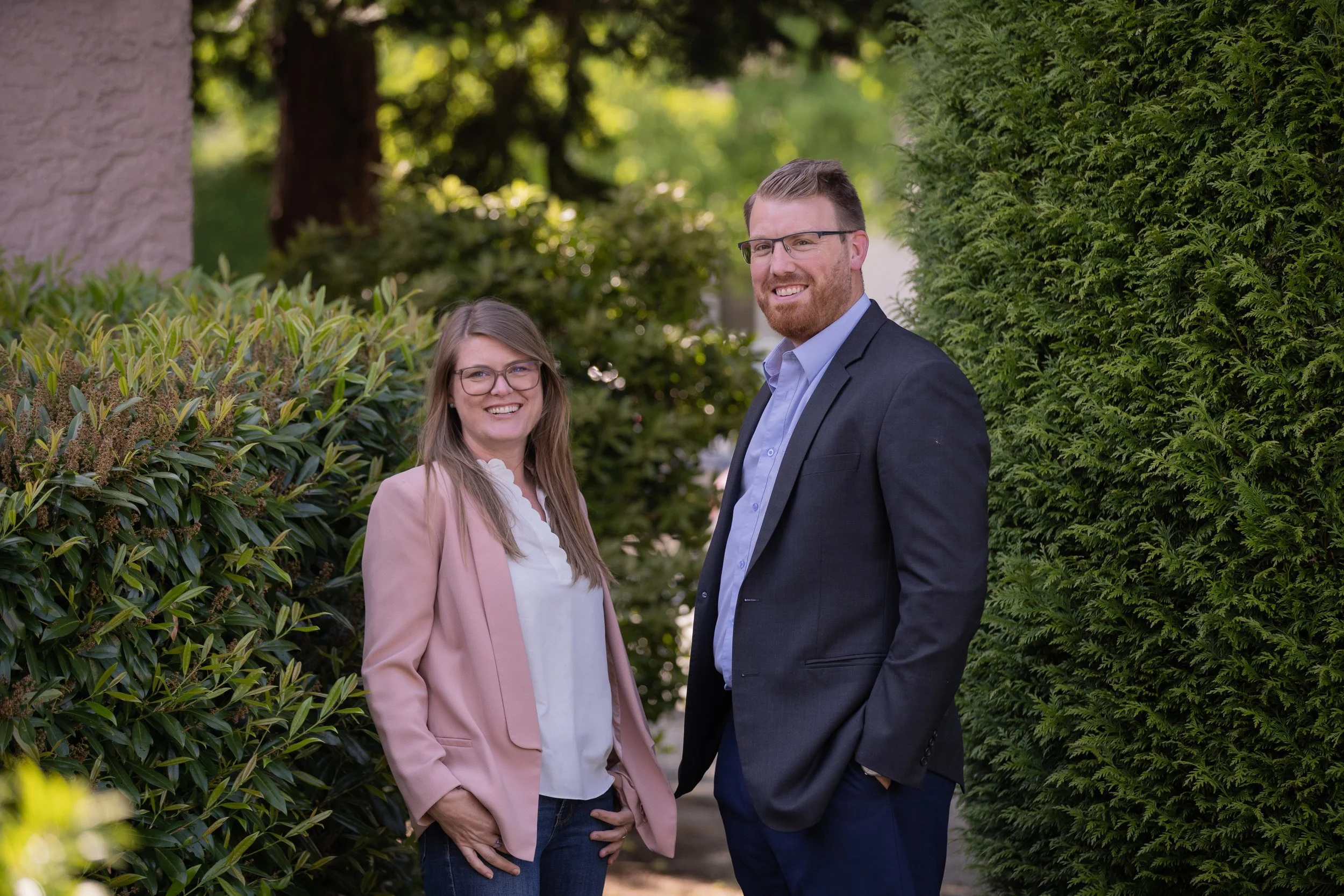 Photos of Brandi Foy, paralegal, and Darnell Smith, lawyer, outside the office in work attire.