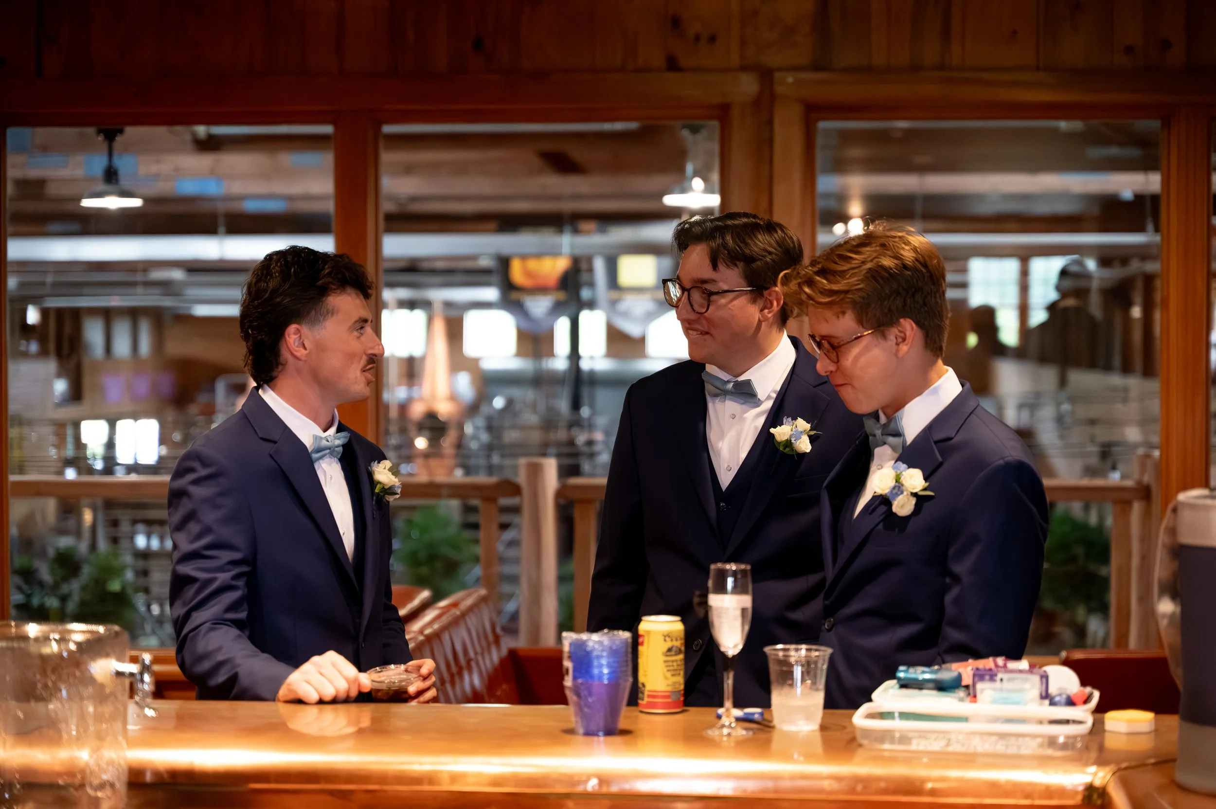 Matt shares drinks with his groomsmen at the upstairs bar at Gypsy Distillery in Petoskey, Michigan.
