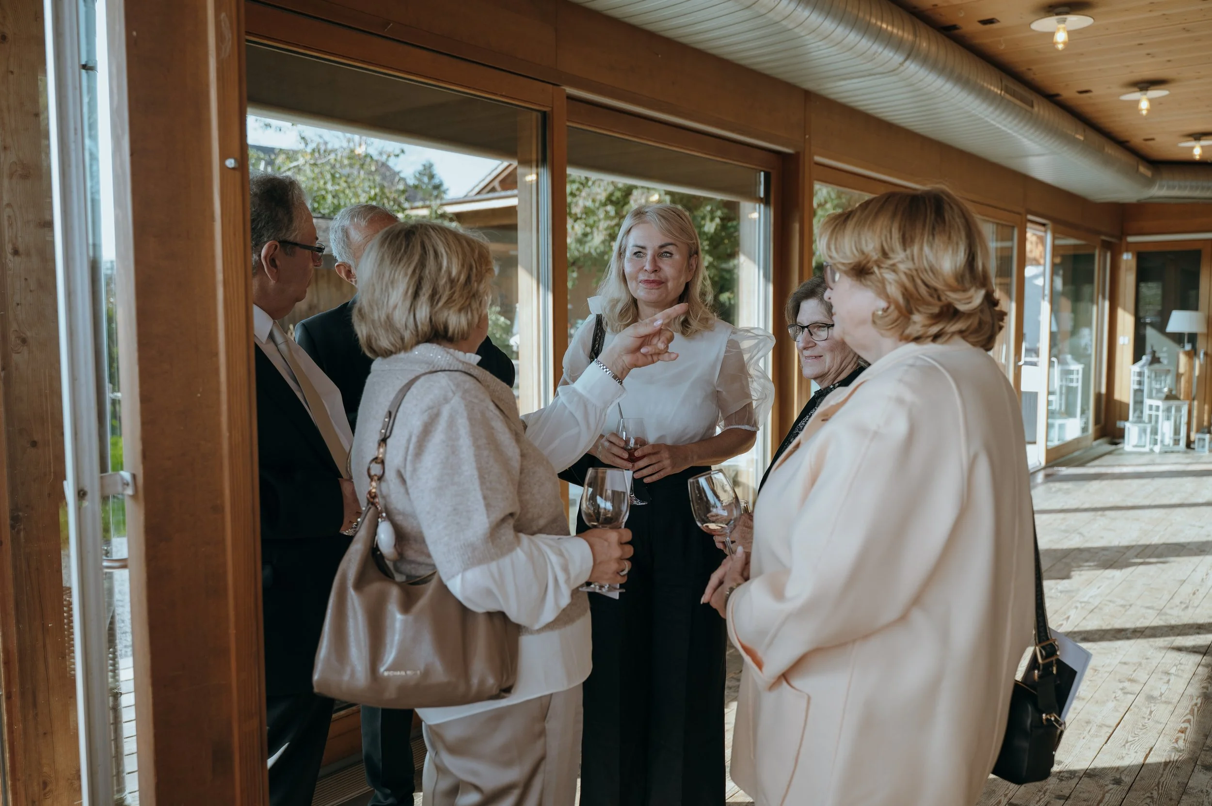 Wedding guests talking together during cocktail hour at Jucker Farm in Rapperswil-Jona, Switzerland