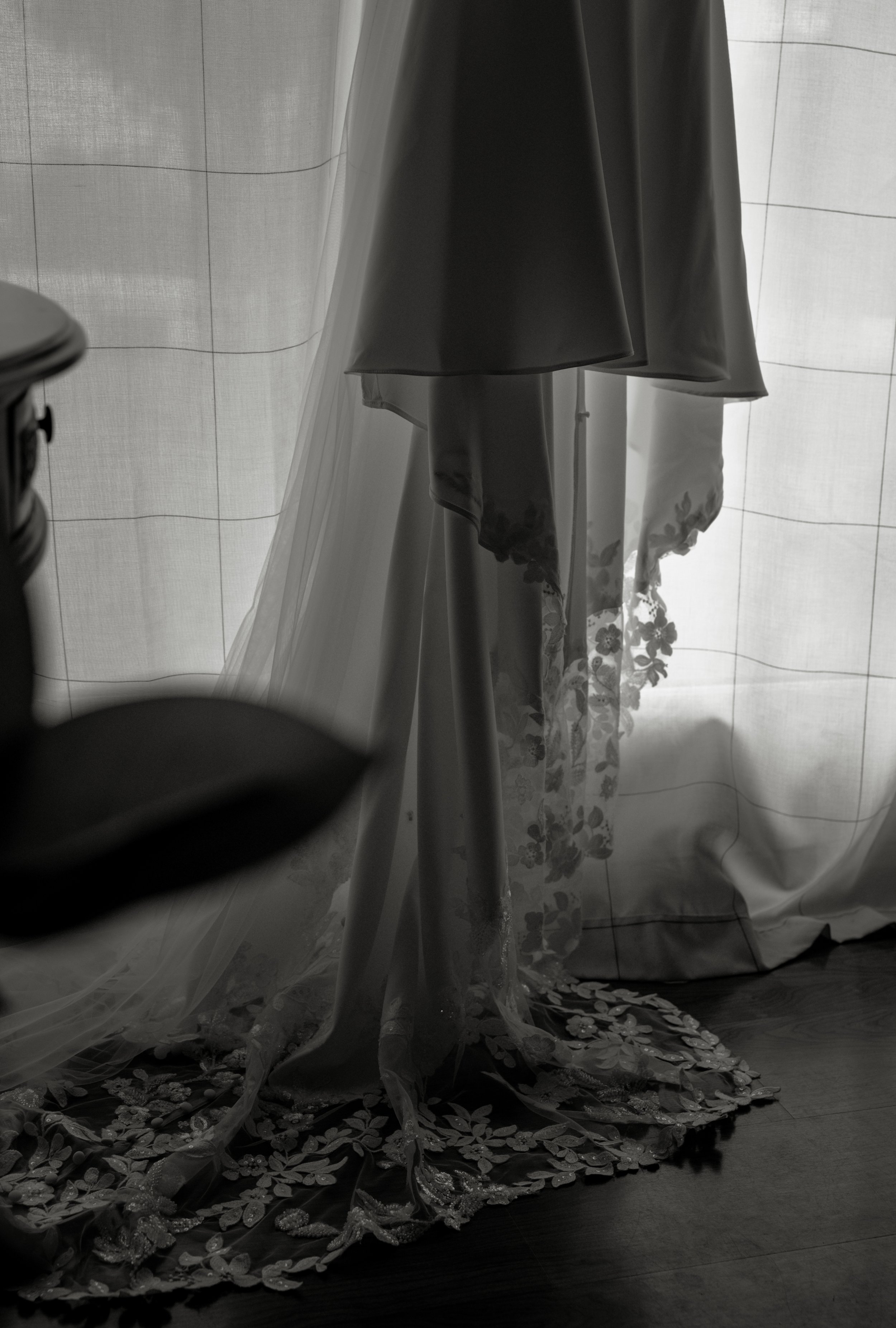 Black-and-white detail of Sydney’s wedding dress and veil during her wedding morning in Petoskey, Michigan.