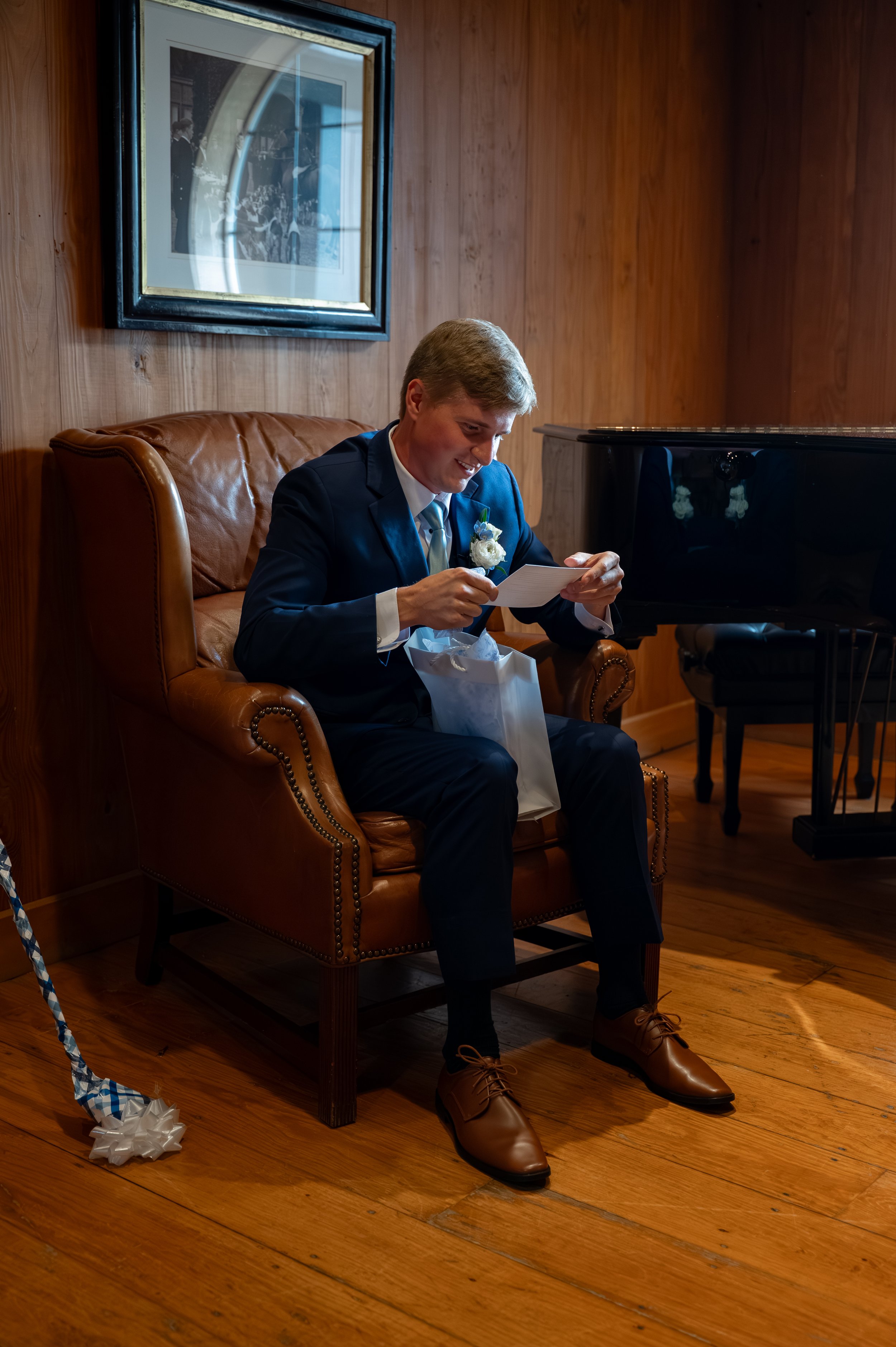 Matt reads a personal note from Sydney before their wedding ceremony in Petoskey, Michigan.