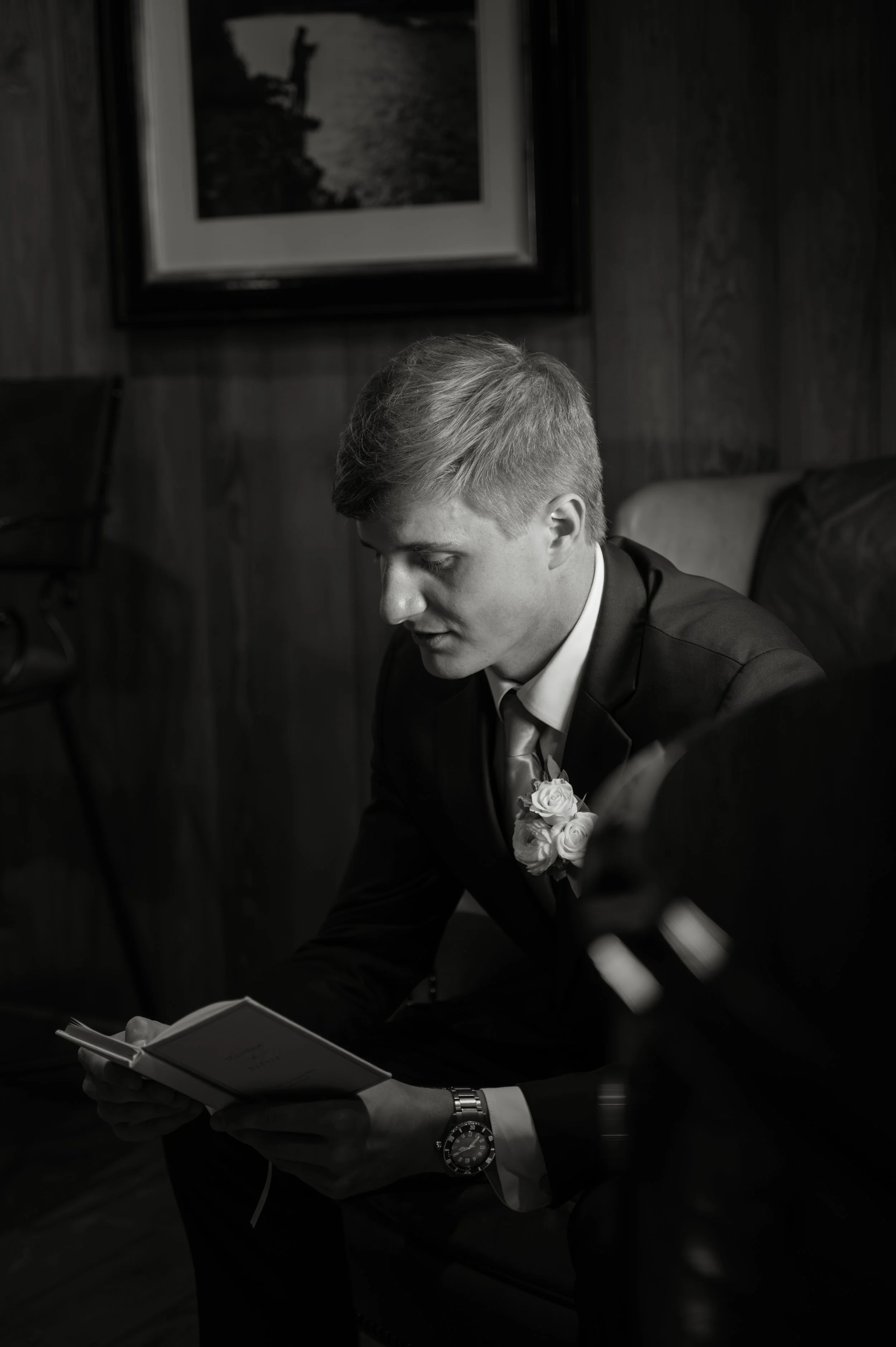 Black-and-white photograph of Matt having a quiet emotional moment while reading Sydney’s wedding note.