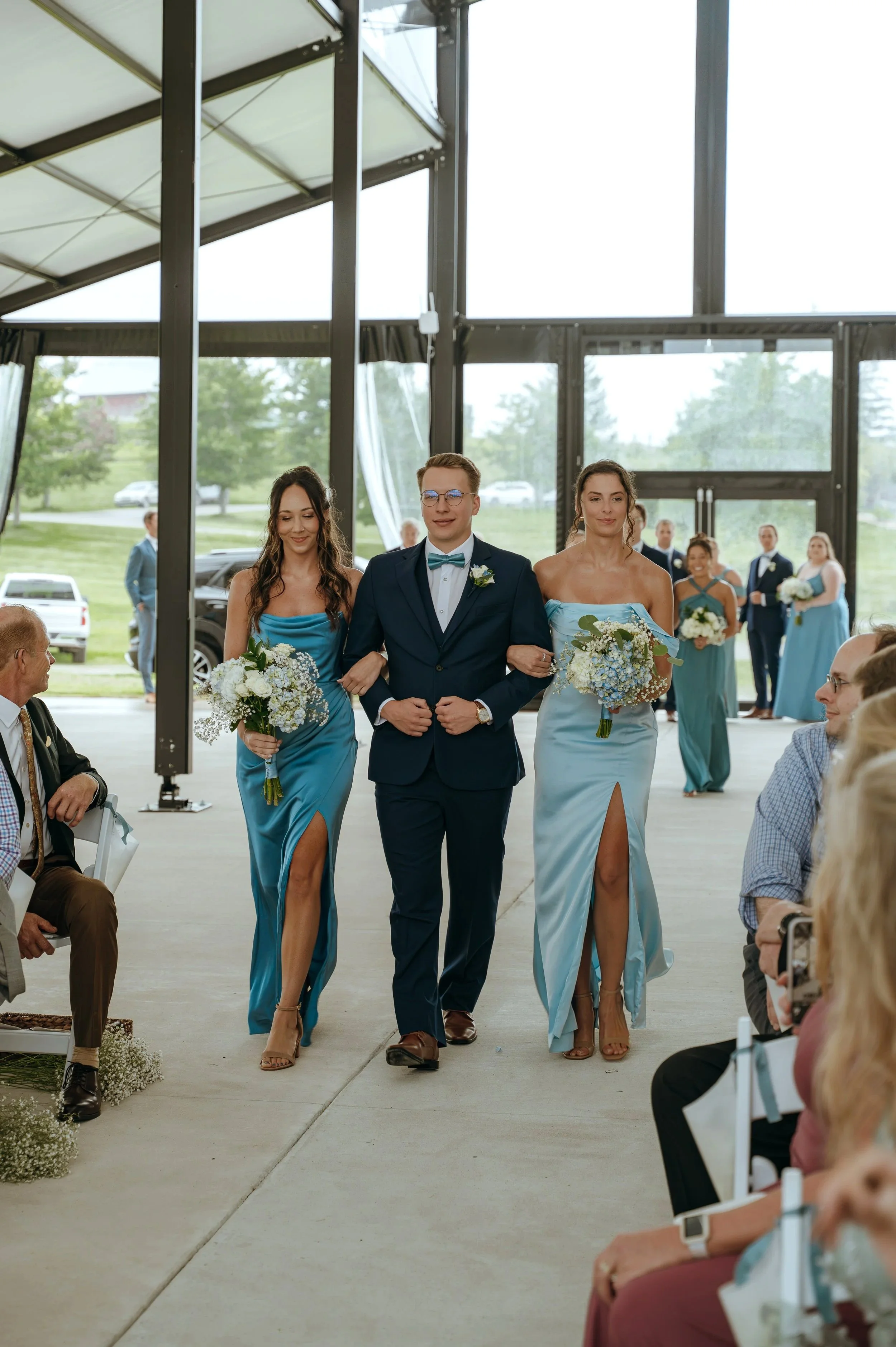Members of Sydney and Matt’s wedding party walk down the aisle during their Gypsy Distillery ceremony.