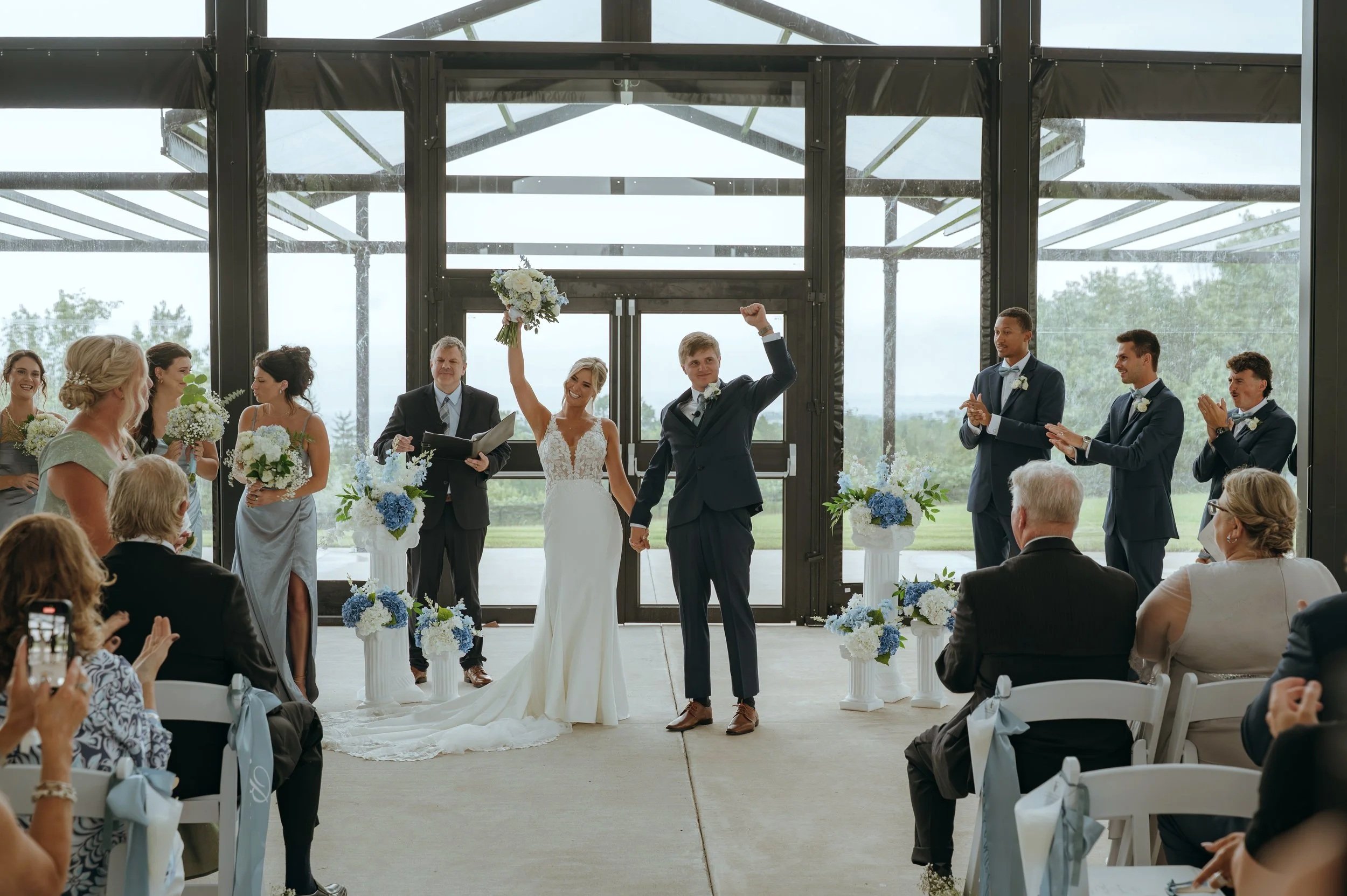 Sydney and Matt celebrate with their wedding party after being pronounced married in Petoskey, Michigan.