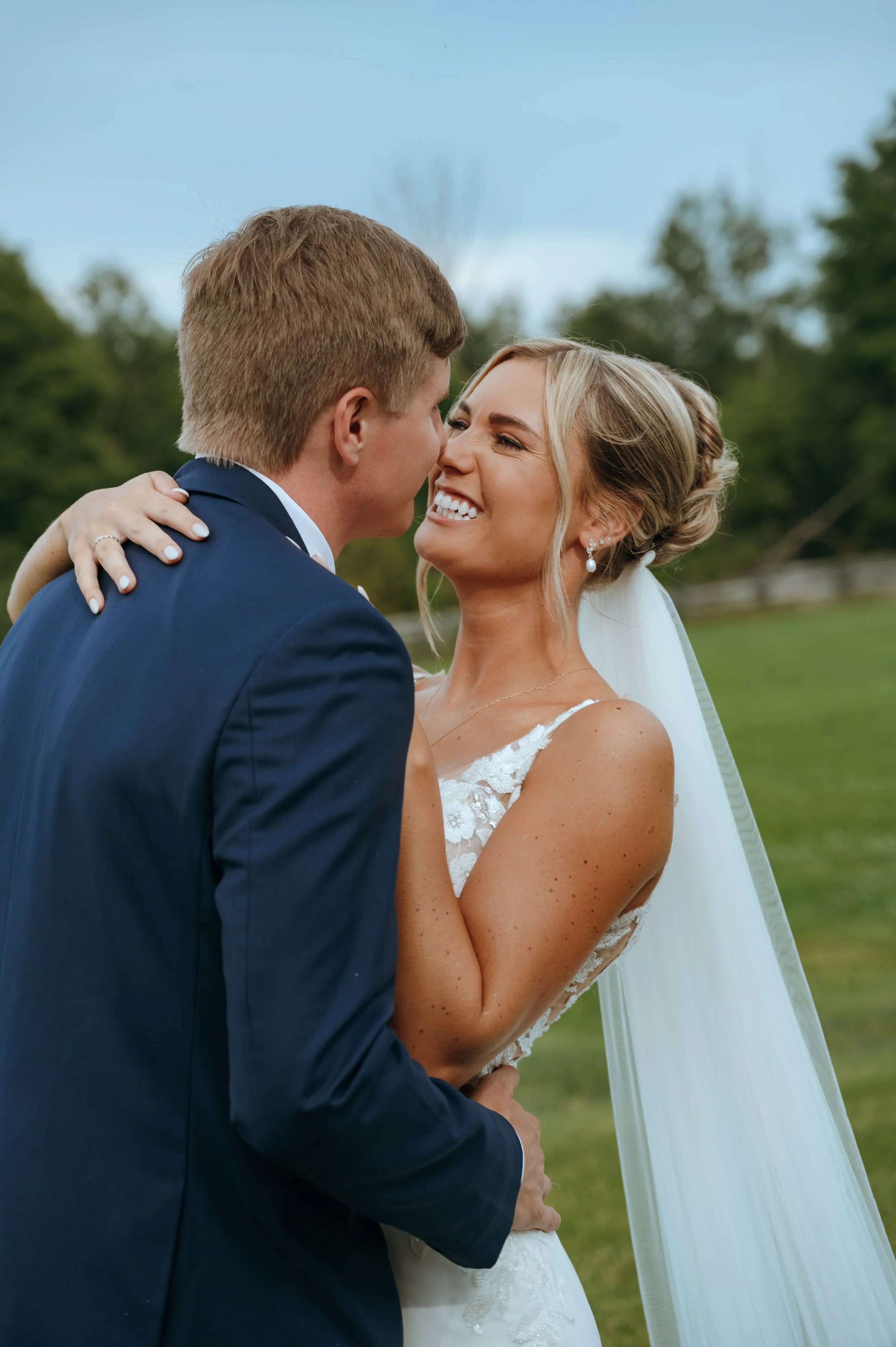 Sydney laughs with Matt during their newlywed portraits at Gypsy Distillery in Petoskey, Michigan.