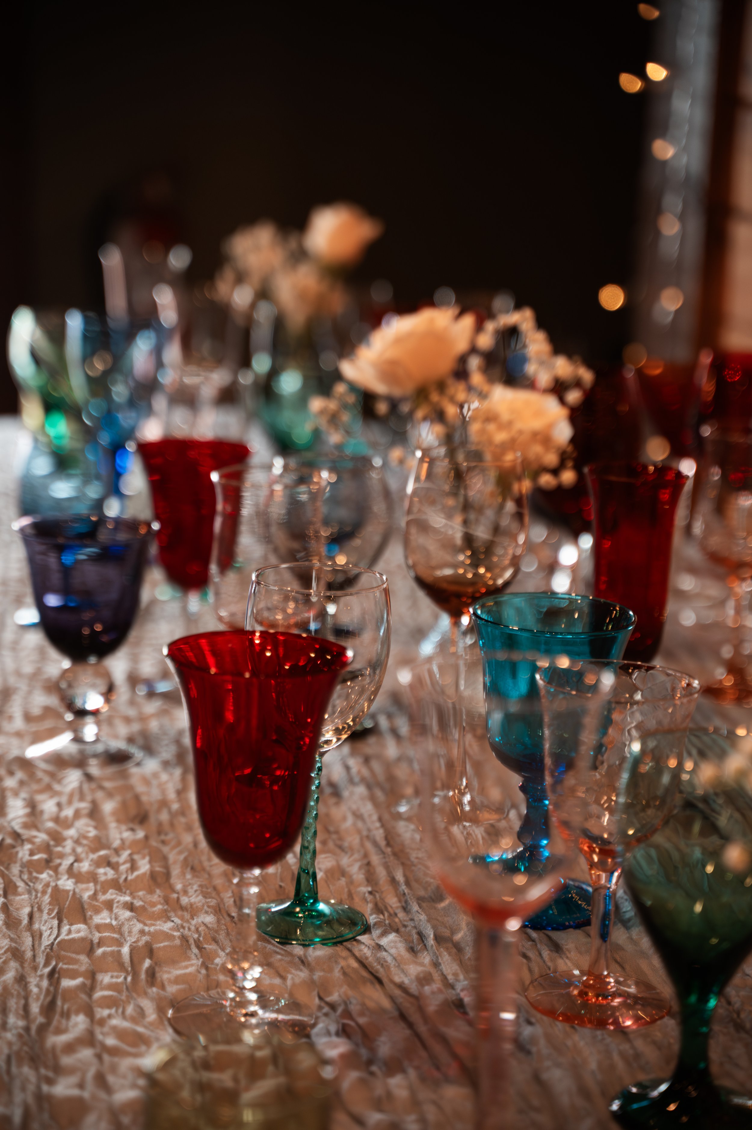 Colorful vintage glasses individually chosen by Sydney and Matt as gifts for their wedding guests.
